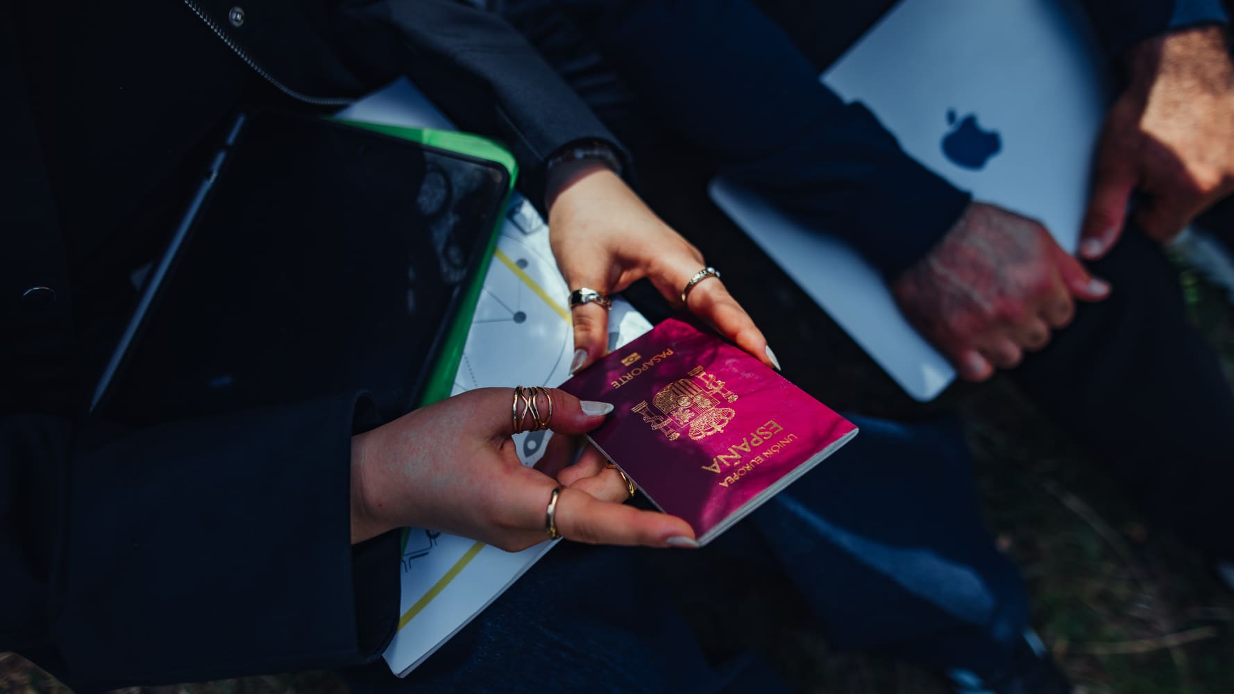 Close-up of female traveler holding Spanish passport, preparing for international study.