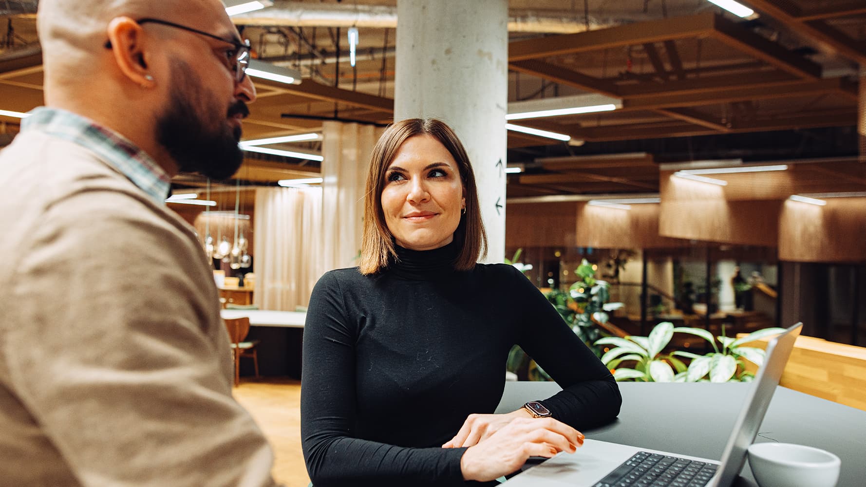 A woman is making an interview to a future employee in a modern office