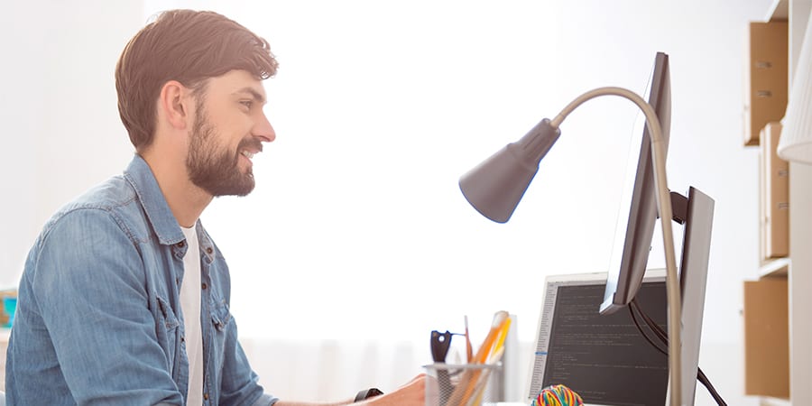 Happy guy taking notes for his artificial intelligence courses