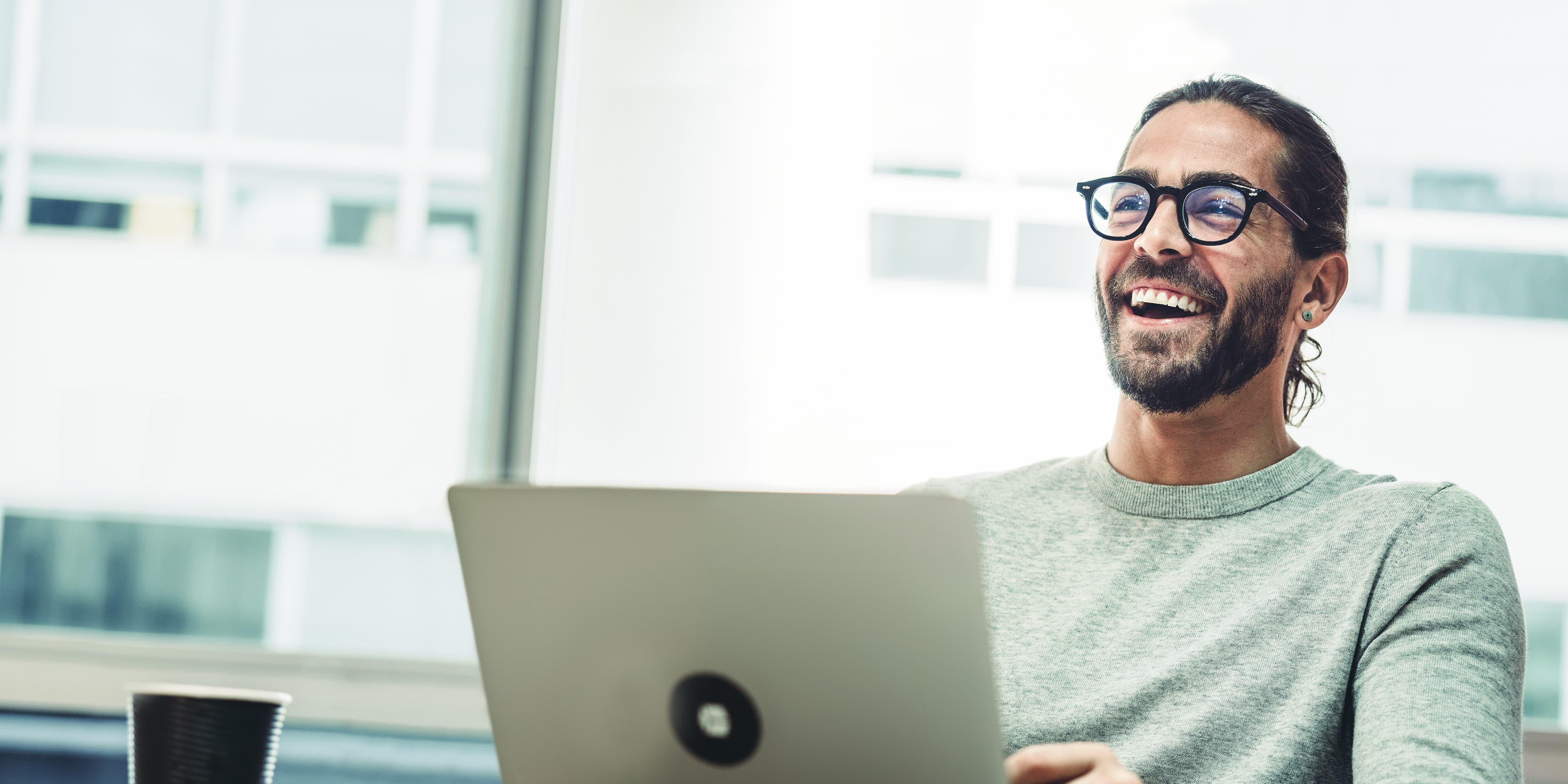 Titelbild für Infoseite “Master Growth Hacking for Entrepreneurs”: Growth Manager arbeitet am Laptop im Büro, AI-generated