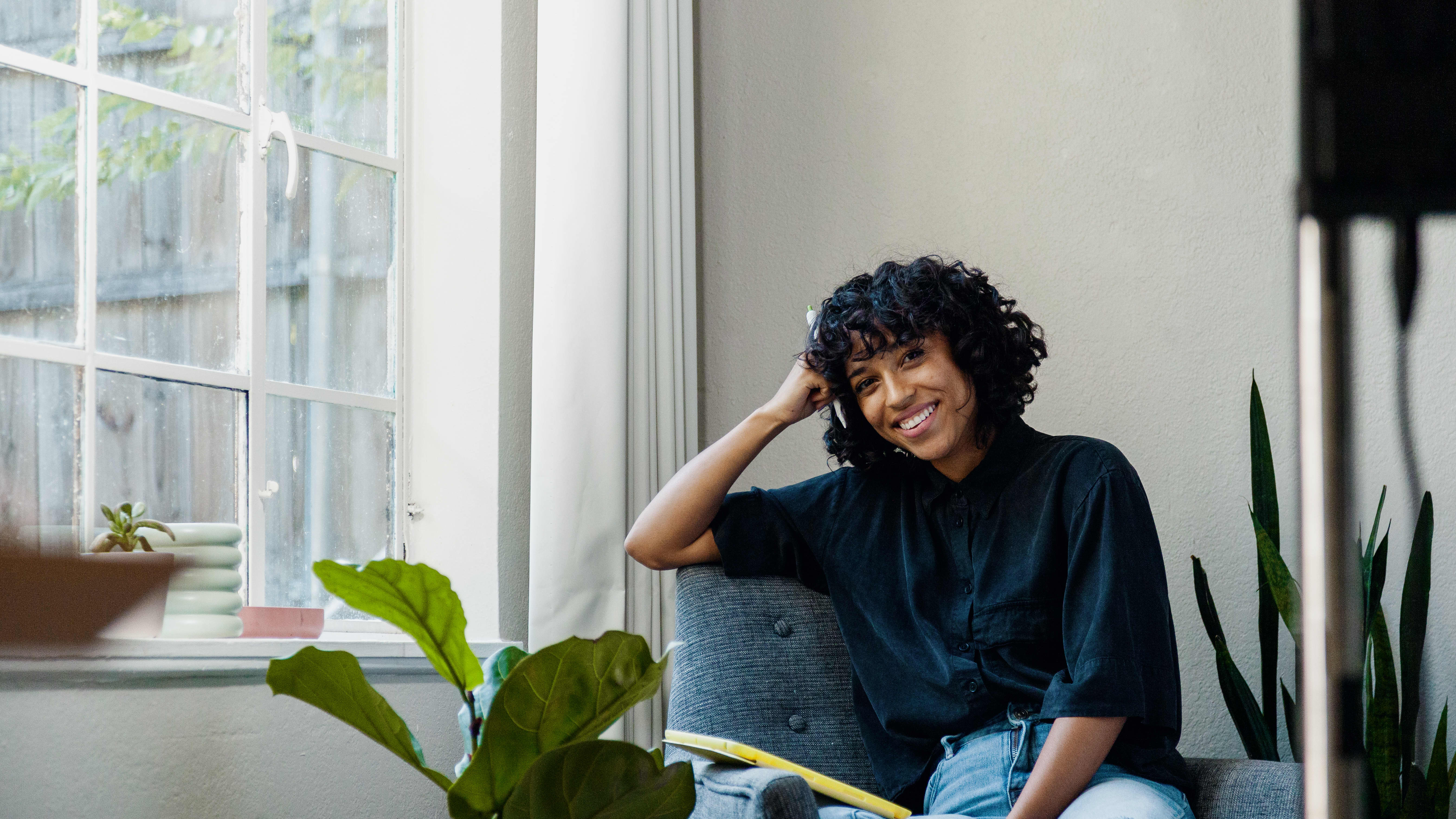 Woman sitting at home considering world wide alternatives universities to the OU