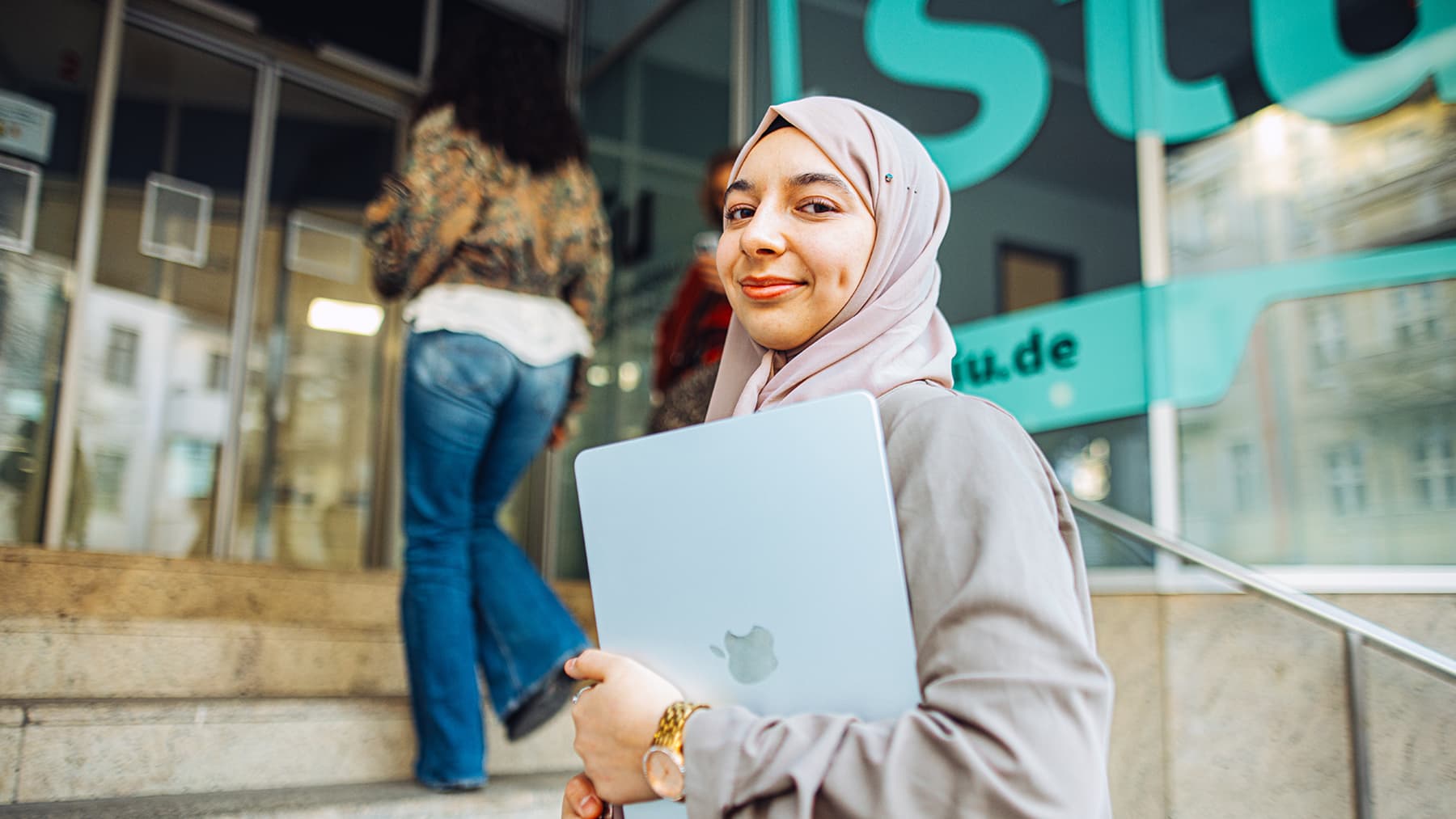 A smiling student walking to computer science class
