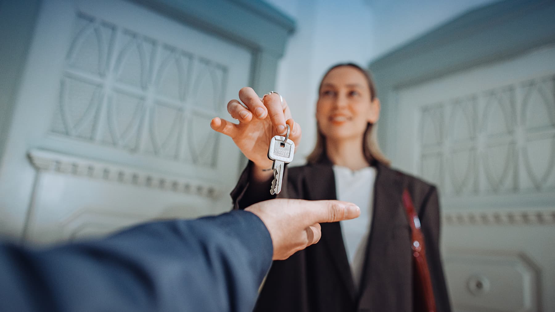 A German real estate agent hands over the keys to your new accommodation