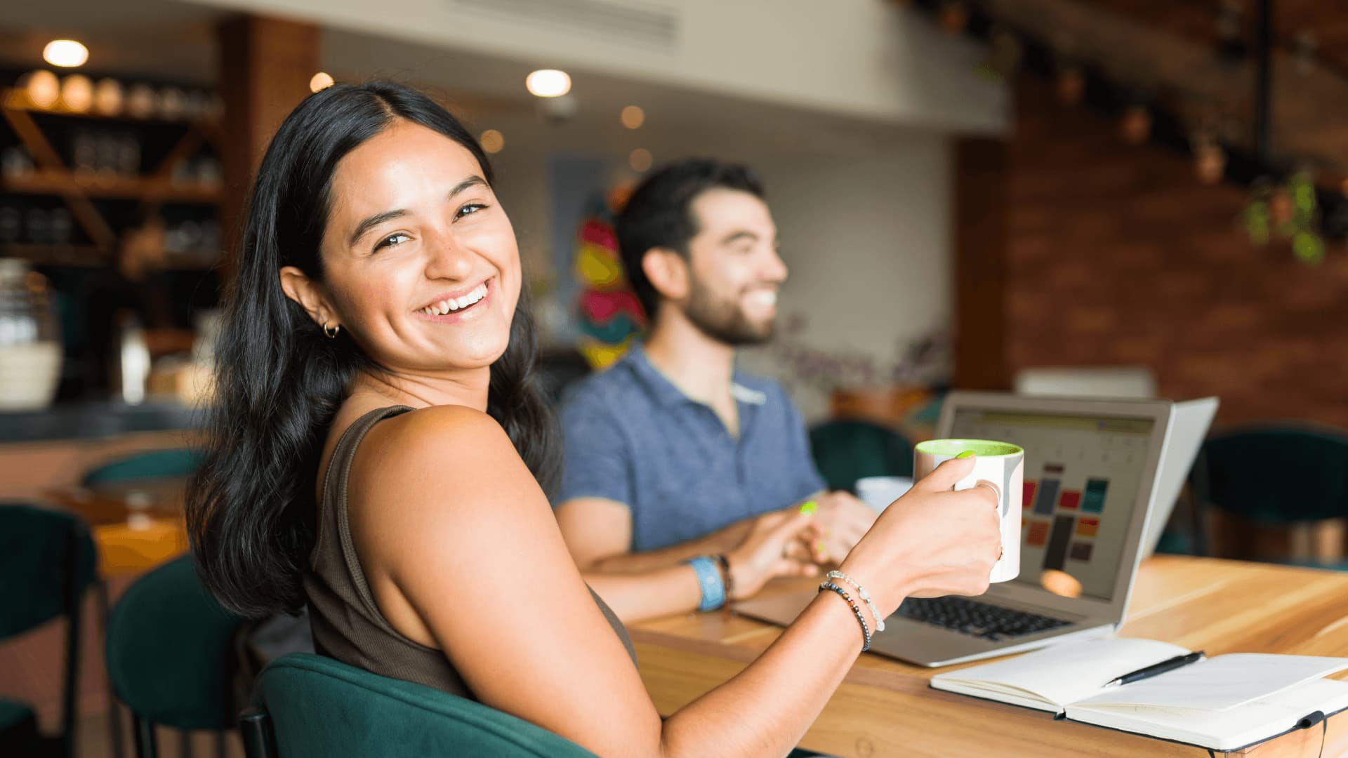 Woman in a cafe conducting an online search for university world rankings.