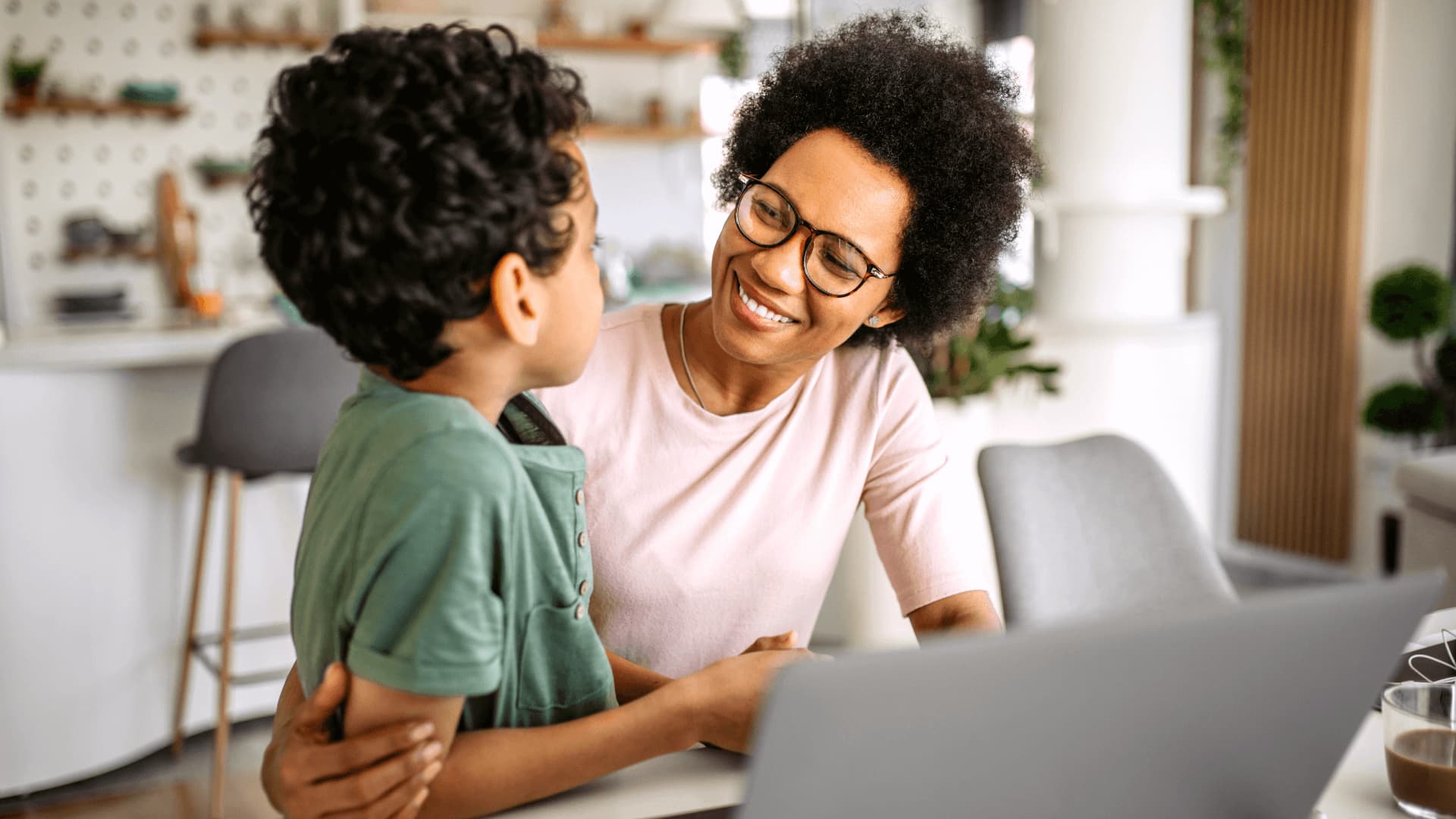 Mother at home with son exploring universities and courses for access to professional development.