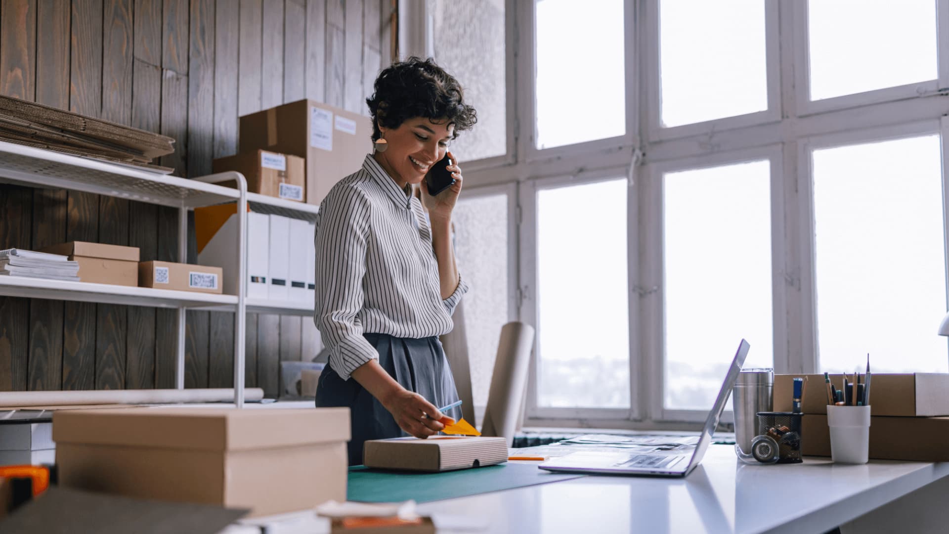 Program manager on the phone working from office.