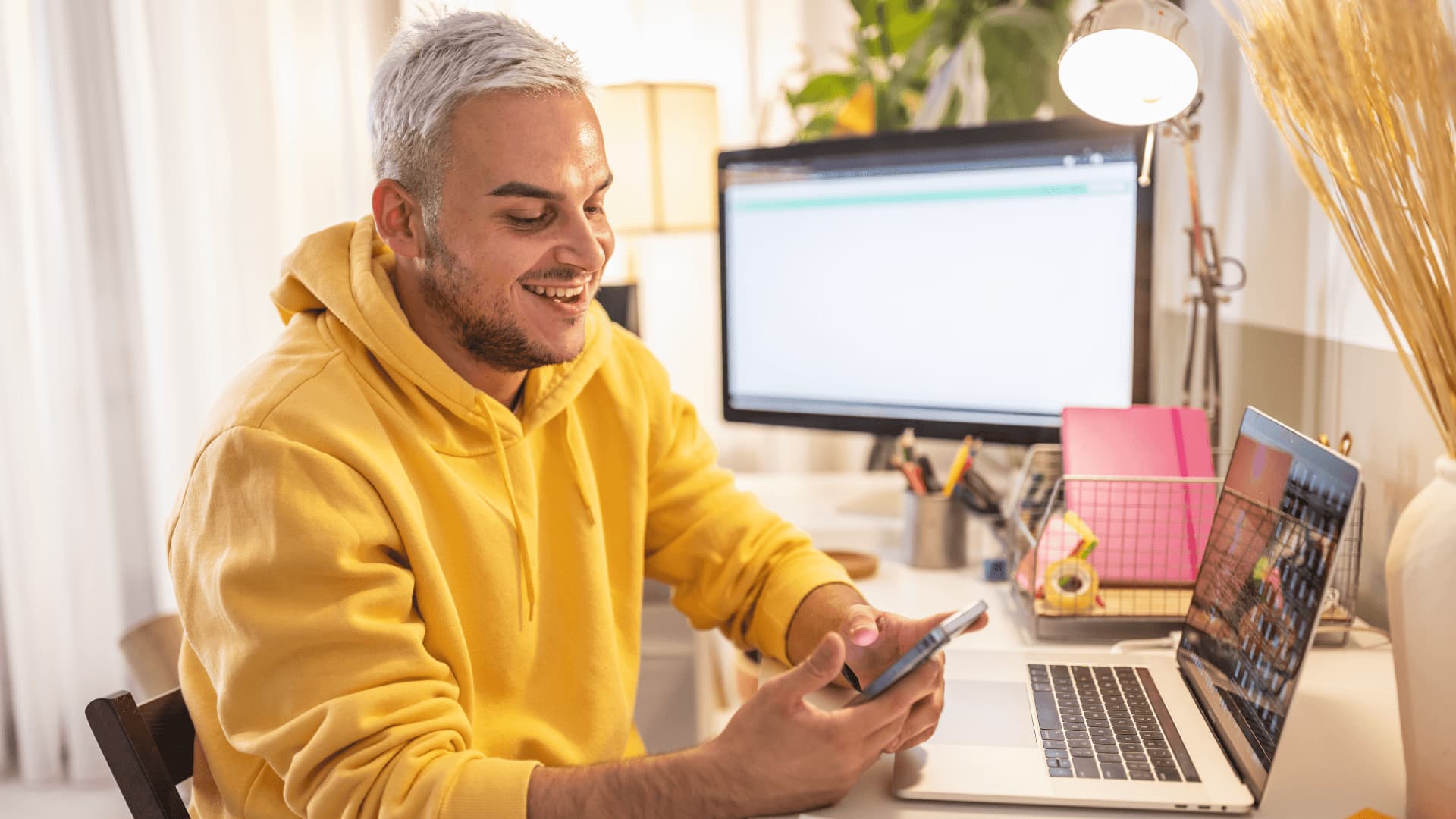 Male university student in yellow hoodie plans for foundation study.