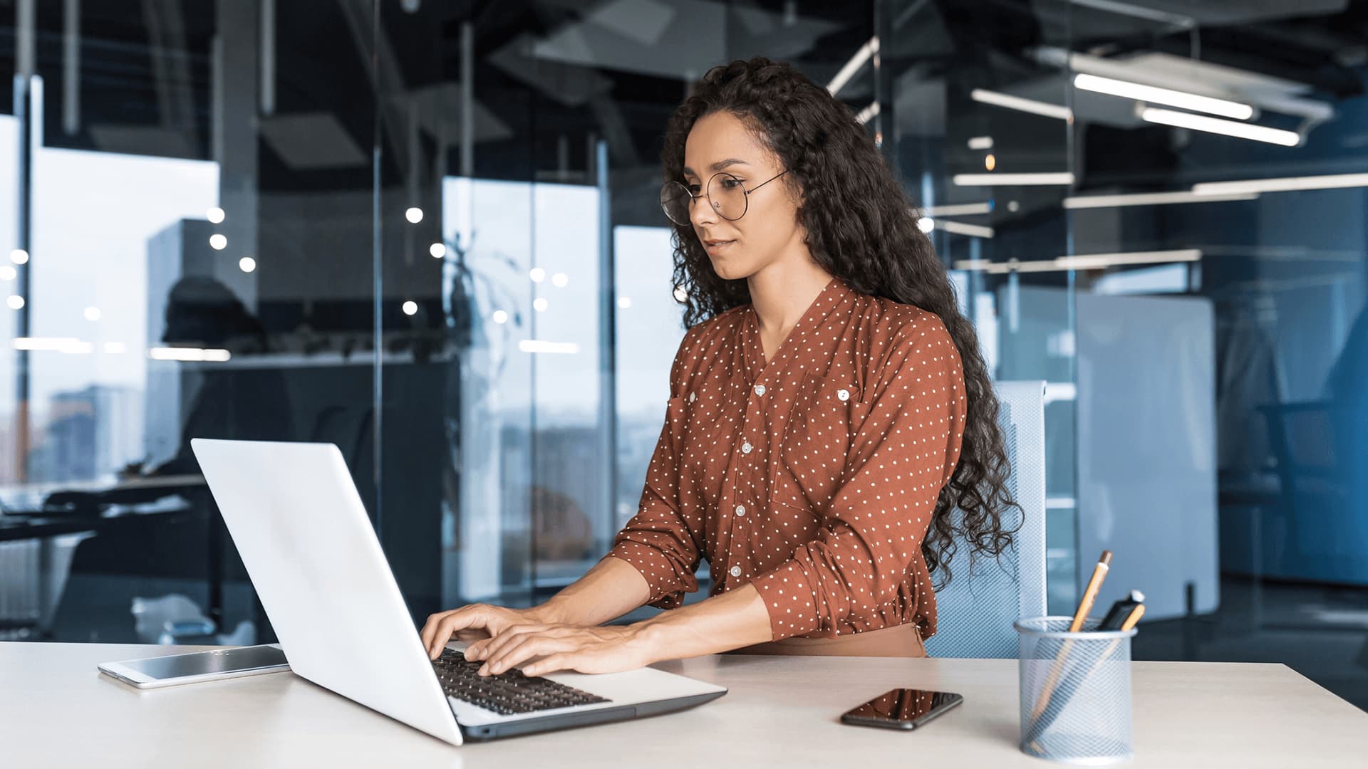 Woman studying for computing degree in lunch break in office.