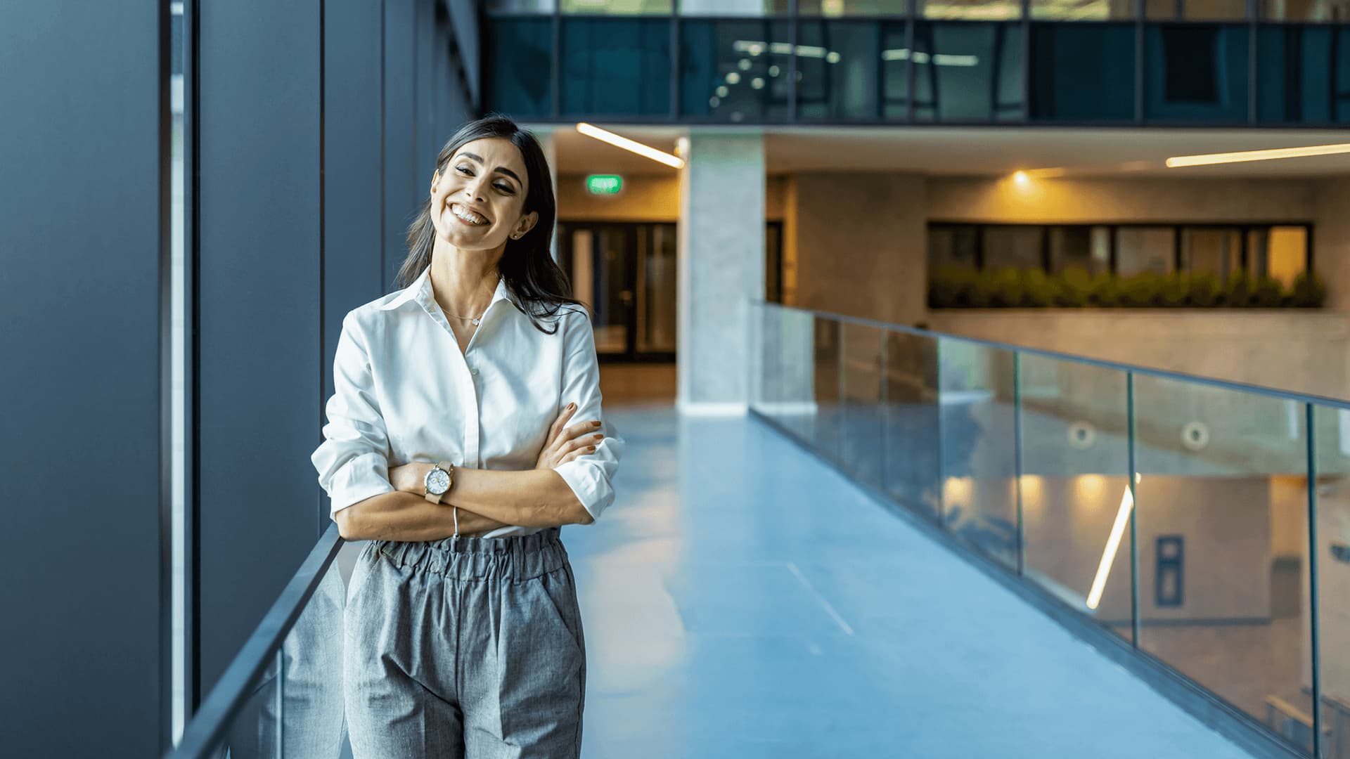 Businesswoman in hallway studying a part-time programme while working full-time.