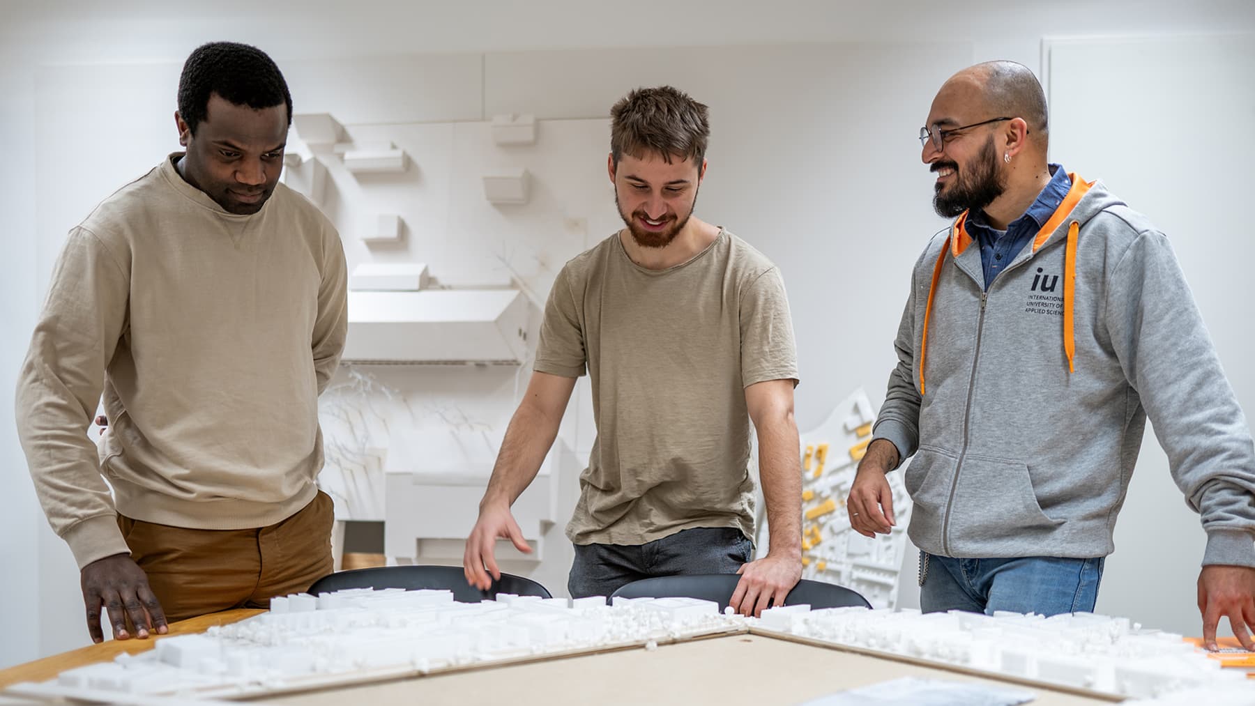 Three students work in a group in a practical learning environment