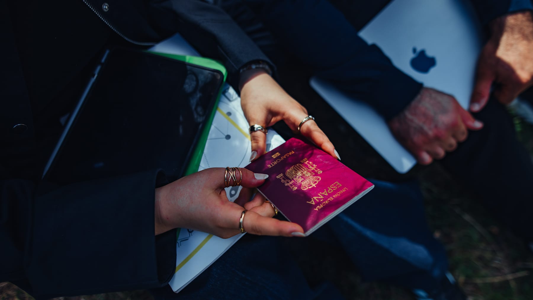 Close-up of female traveler holding Spanish passport, preparing for international study.