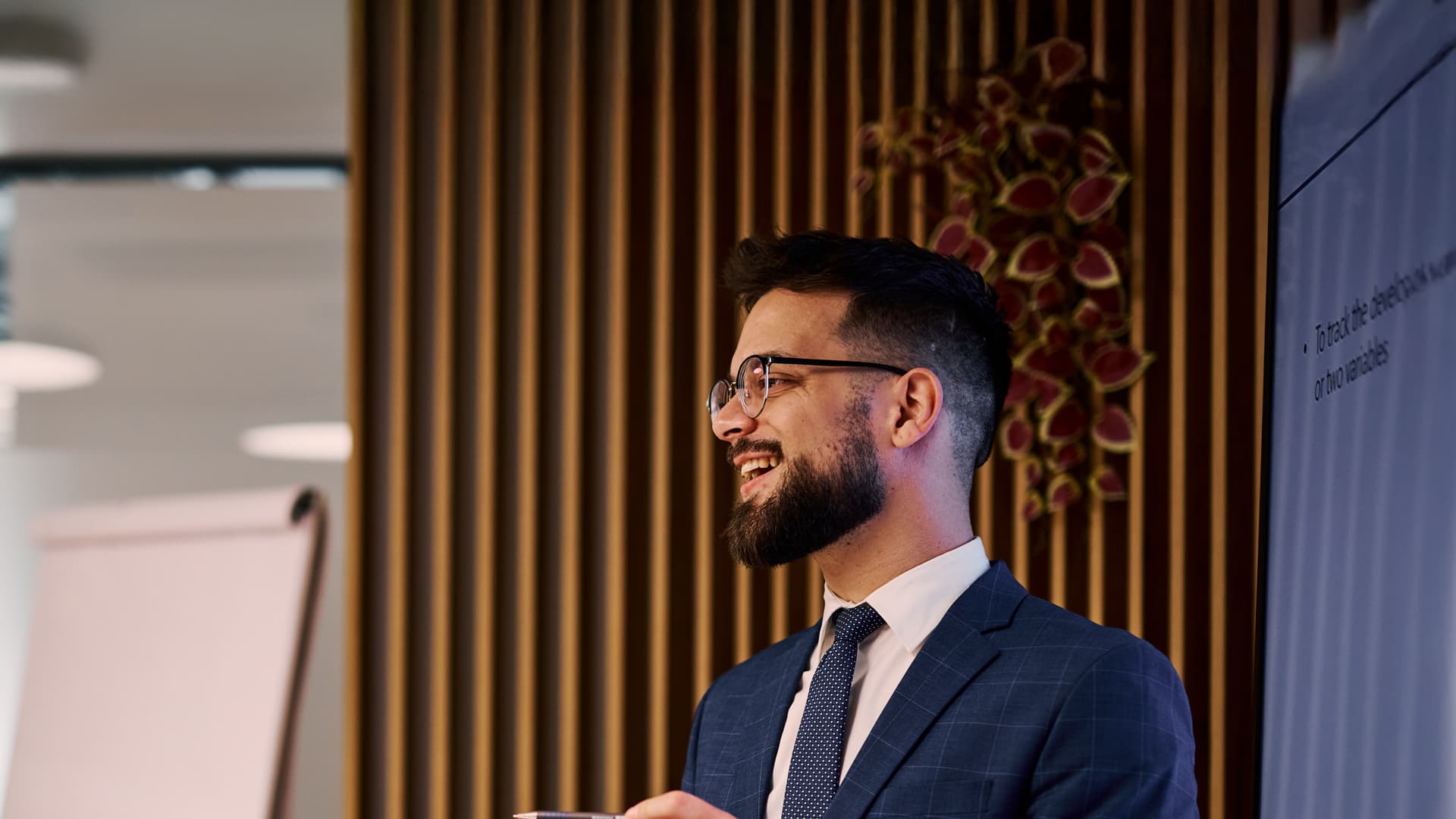 Smiling professional running a meeting about current financial markets and risk management.