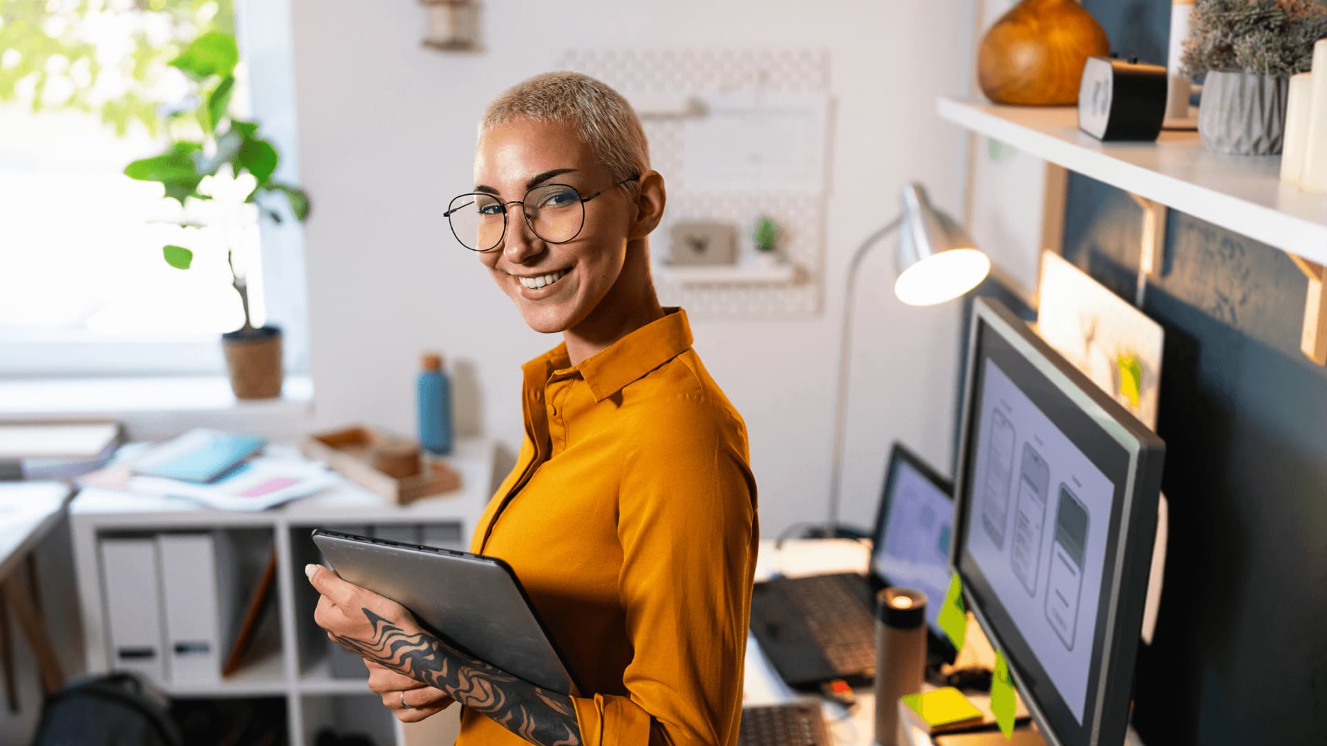 Woman in yellow shirt in home office planning a career in international business management.