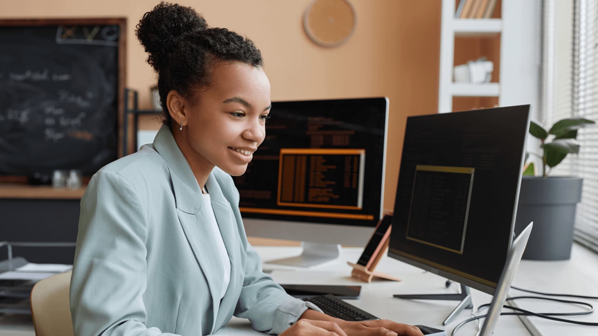 Woman in light blue blazer preparing to change subjects and study a university degree in computing.