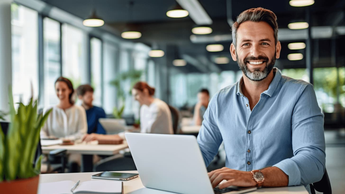 Man wearing a blue shirt in his office is working as AI research scientist