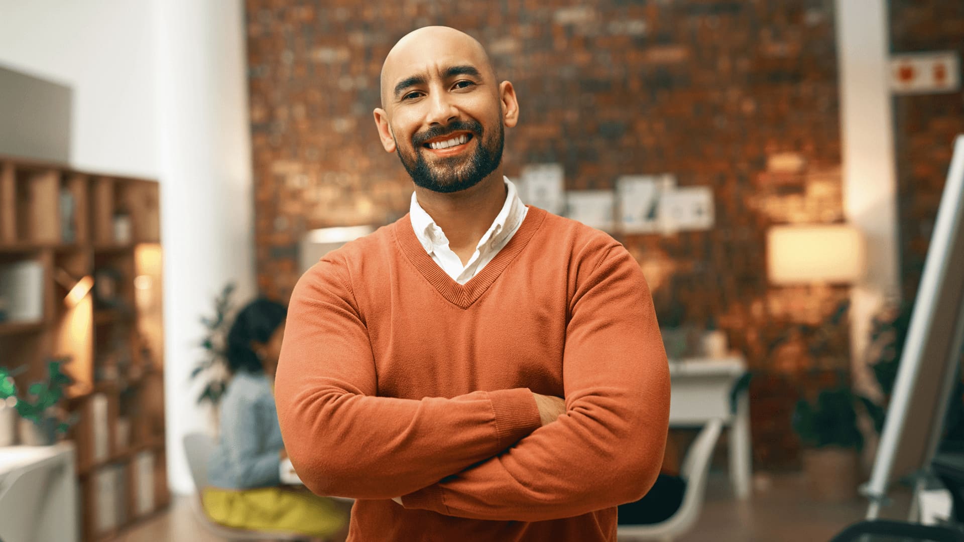 Business man in orange jumper considering universities with flexible entry requirements and access courses.