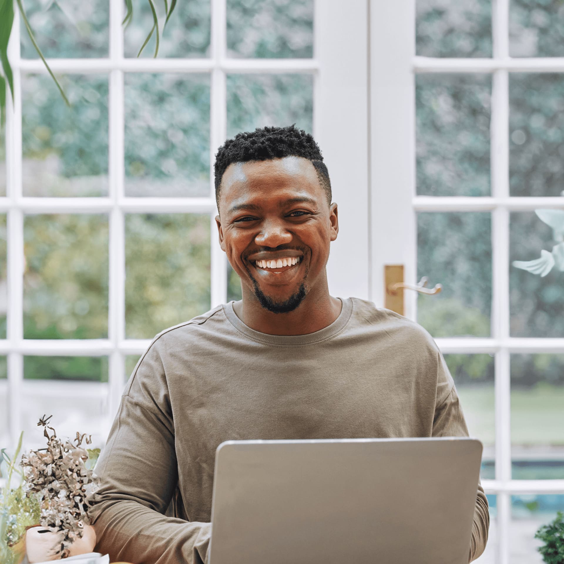 Smiling man research cost of university online degrees.