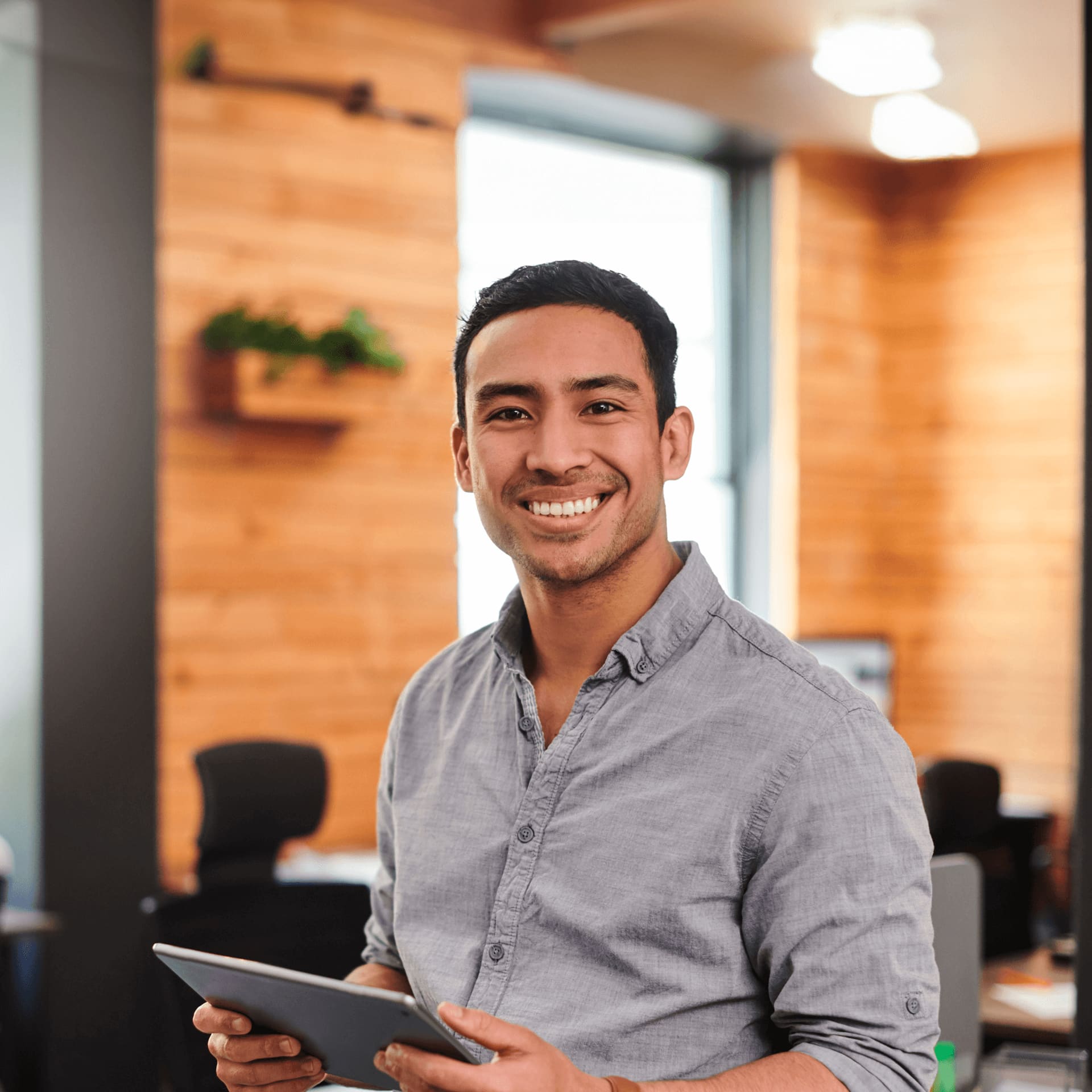 Young male professional in grey shirt explore masters courses after completing a bachelors degree.