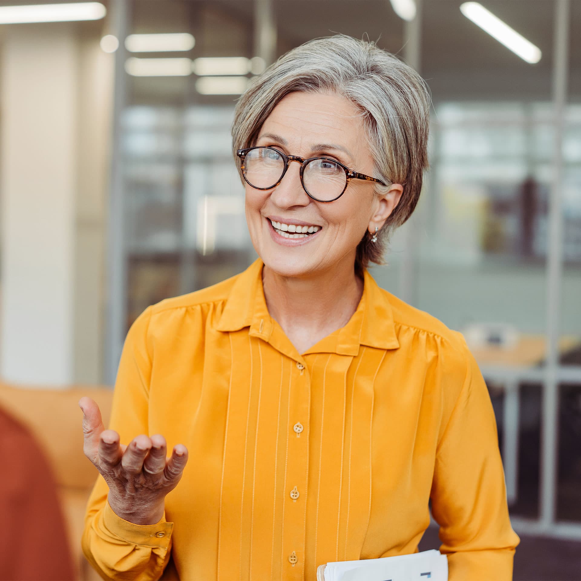 A woman explaining something and smiling.