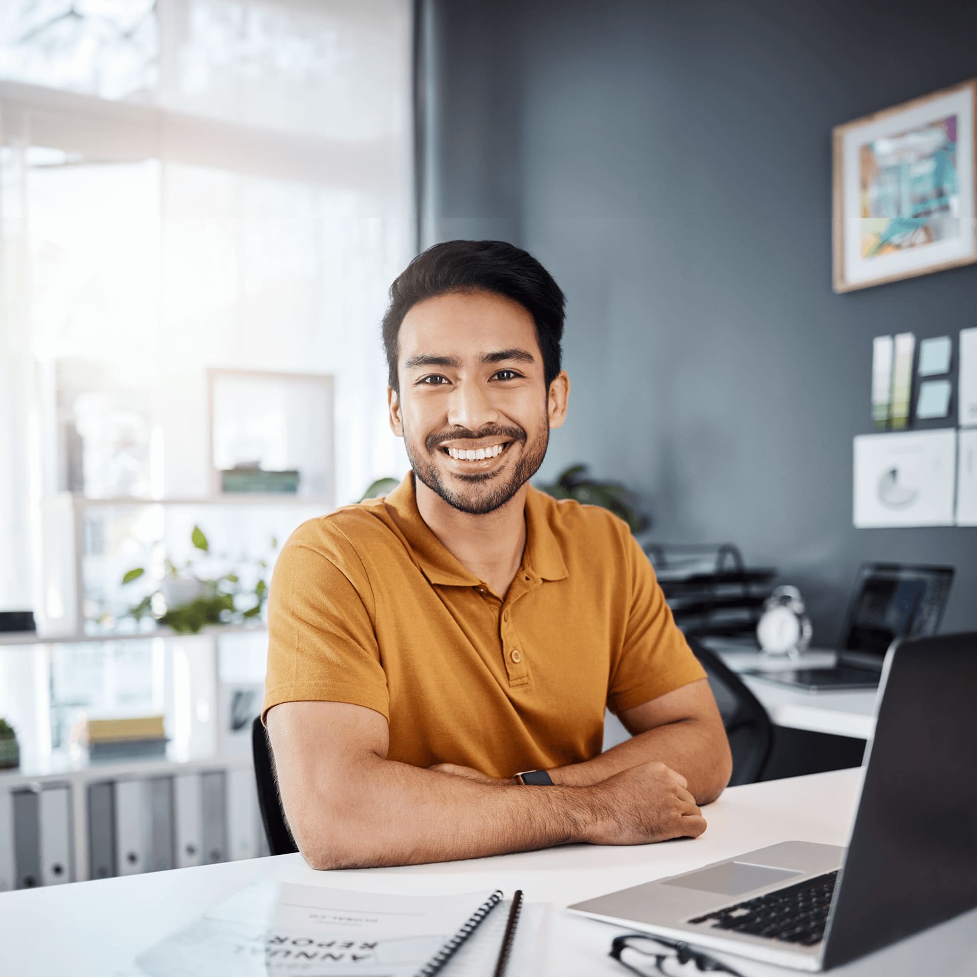 Smiley guy sitting in an office is happy to receive the bachelor in business information systems