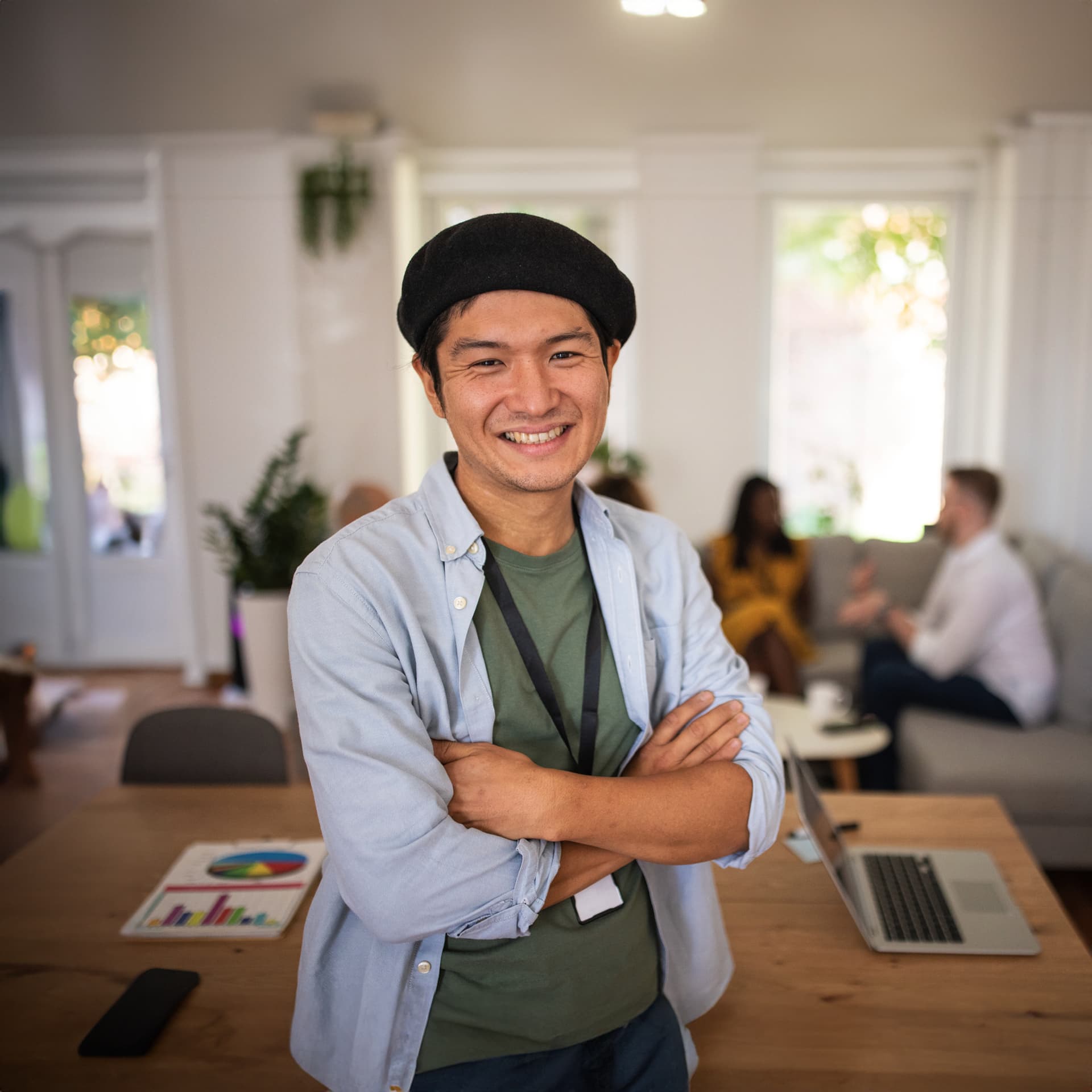 Happy guy wearing a black beret is satisfied with his online master in data management classes