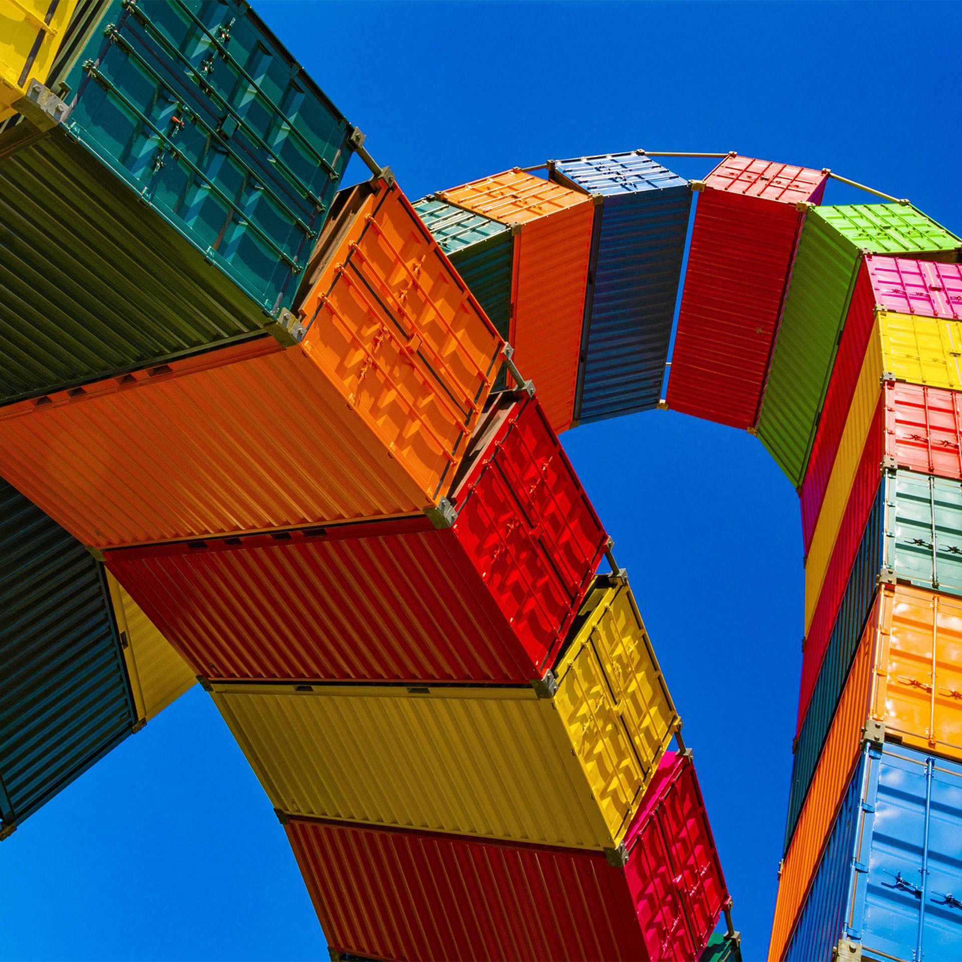 A tower of container ships and a blue sky.