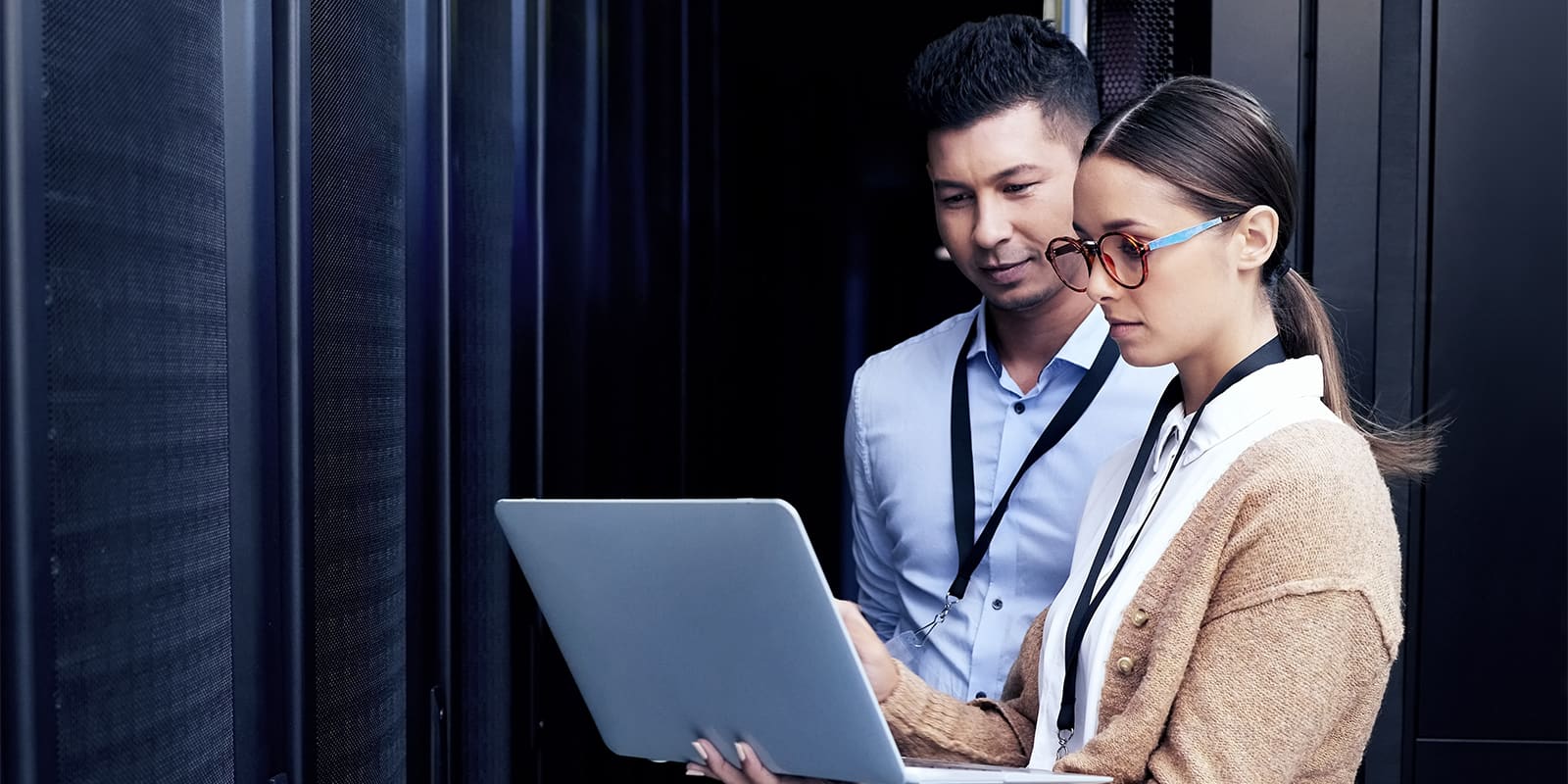 Two computer scientists reviewing work together on a laptop