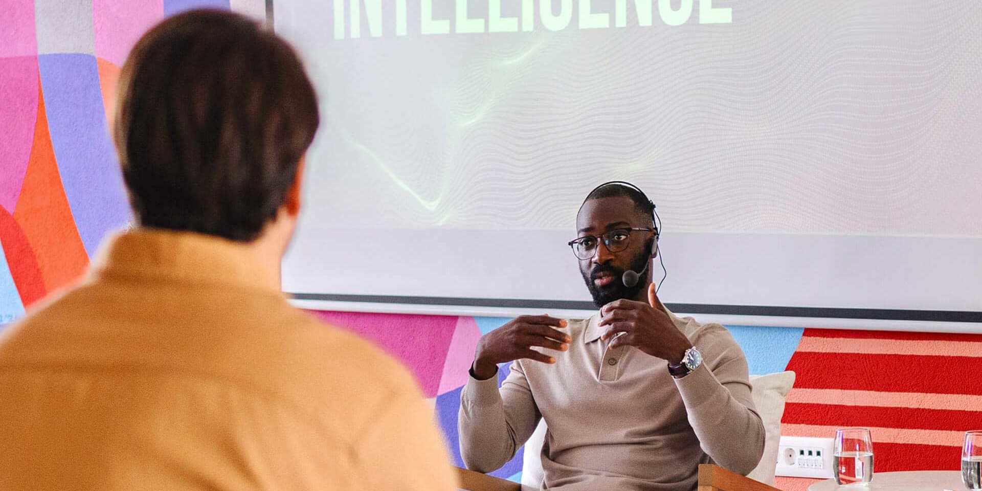 Confident MBA Artificial Intelligence graduate presents new ideas in a collaborative professional setting.