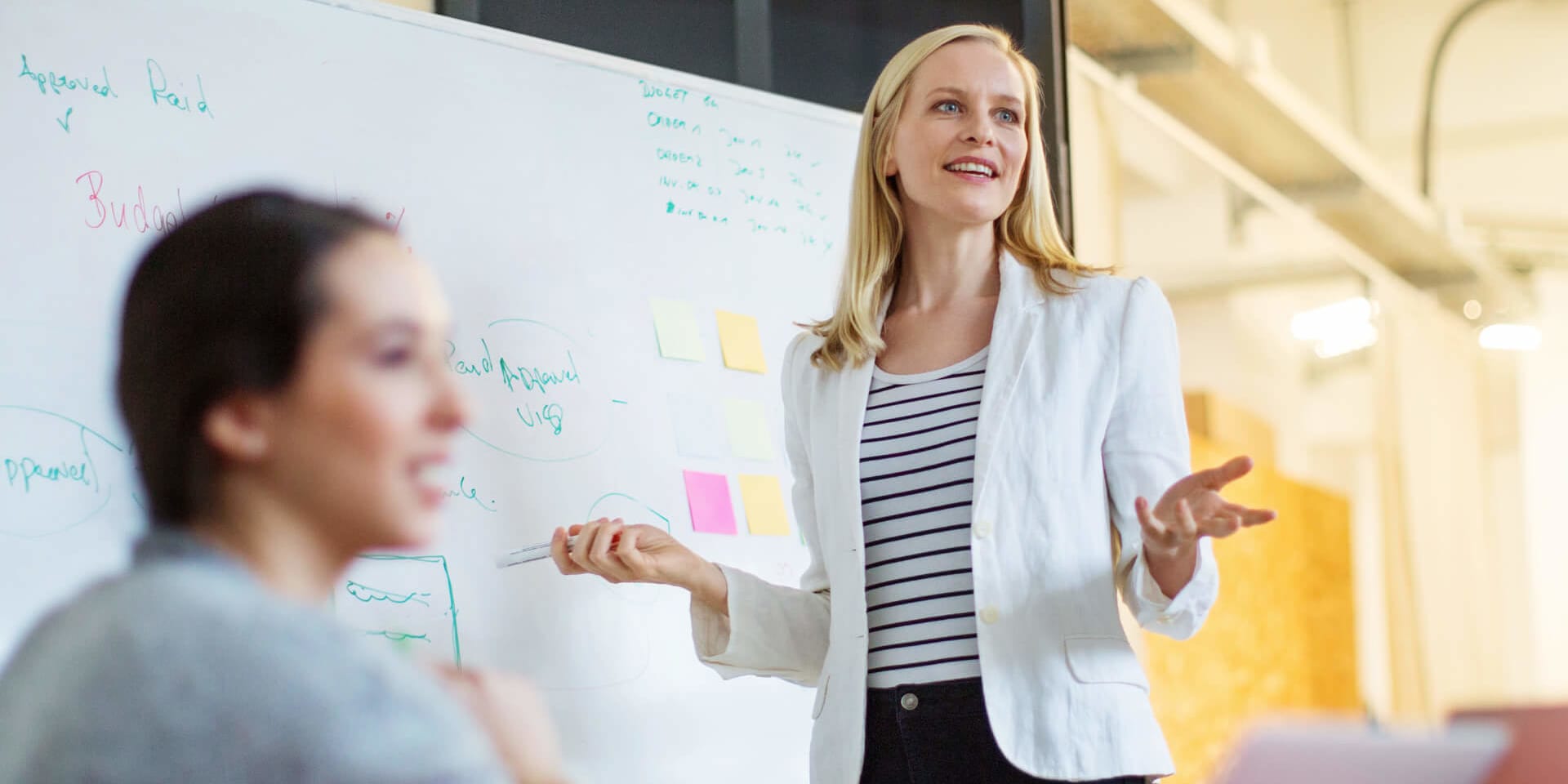 Confident MBA Innovation graduate shares new strategies in an agile team session focused on creative solutions.