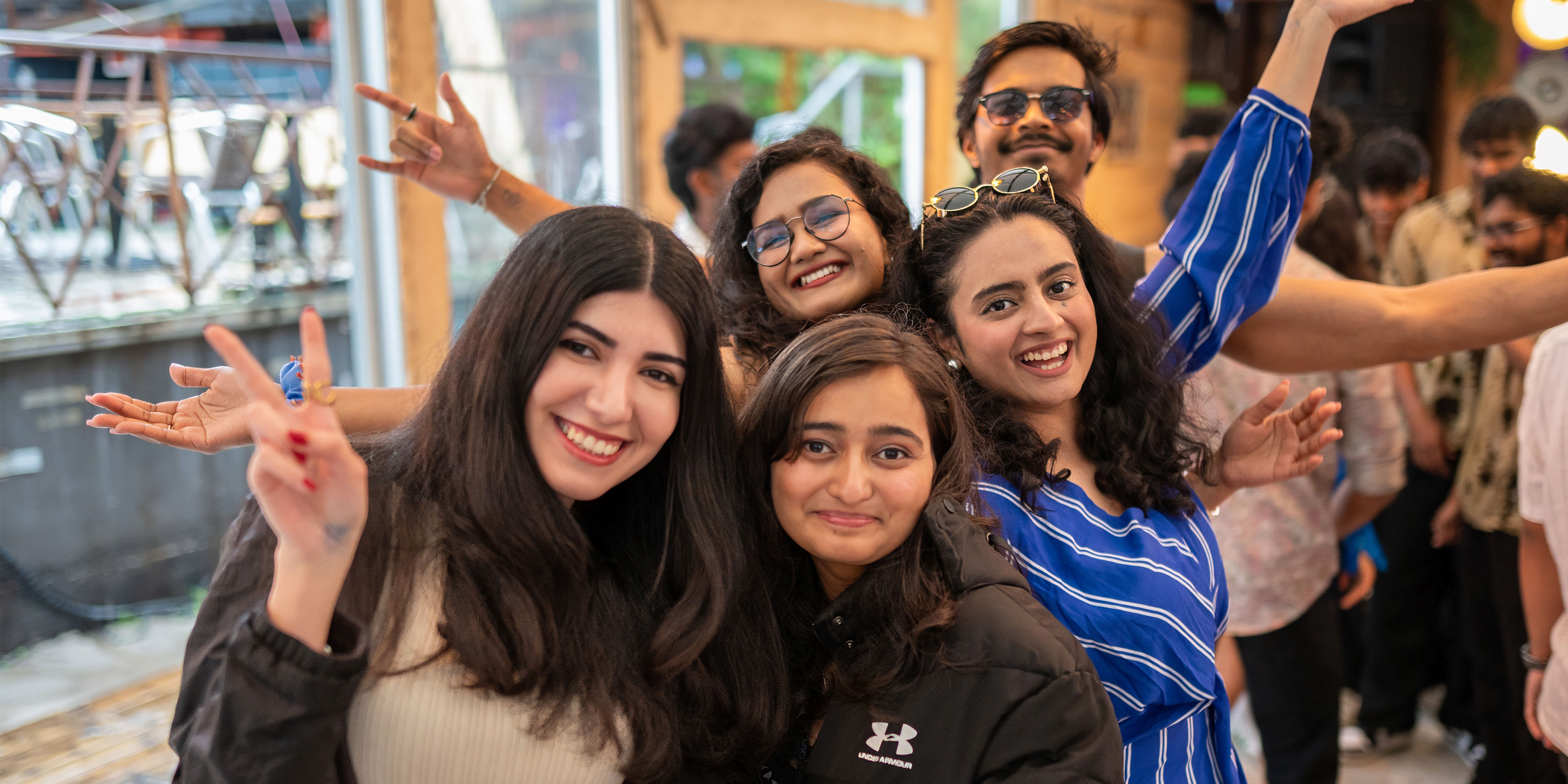 A group of international students posing for a picture at an IU party to depict international student life in Germany.