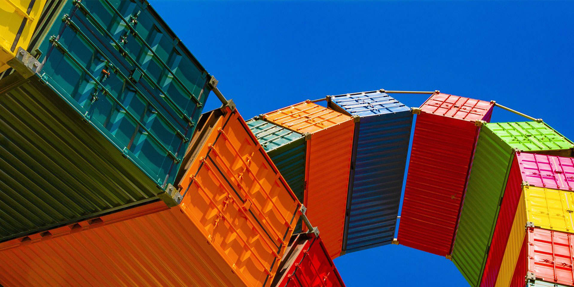 A tower of container ships and a blue sky.