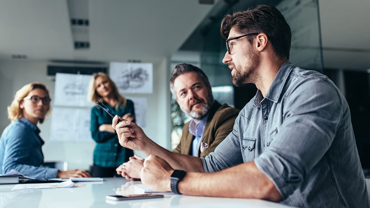 Students engaging in a discussion during a group project in a modern classroom, highlighting collaborative learning in a BBA program in Germany.-