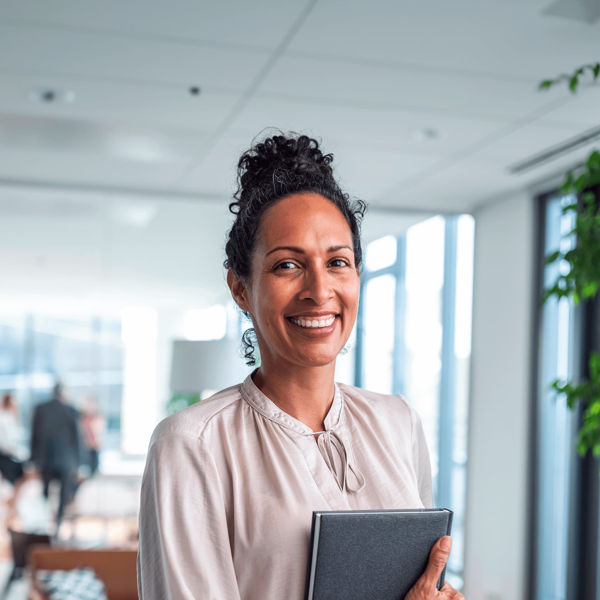 A smartly dressed woman holding a tablet, preparing for a meeting in Marketing Management