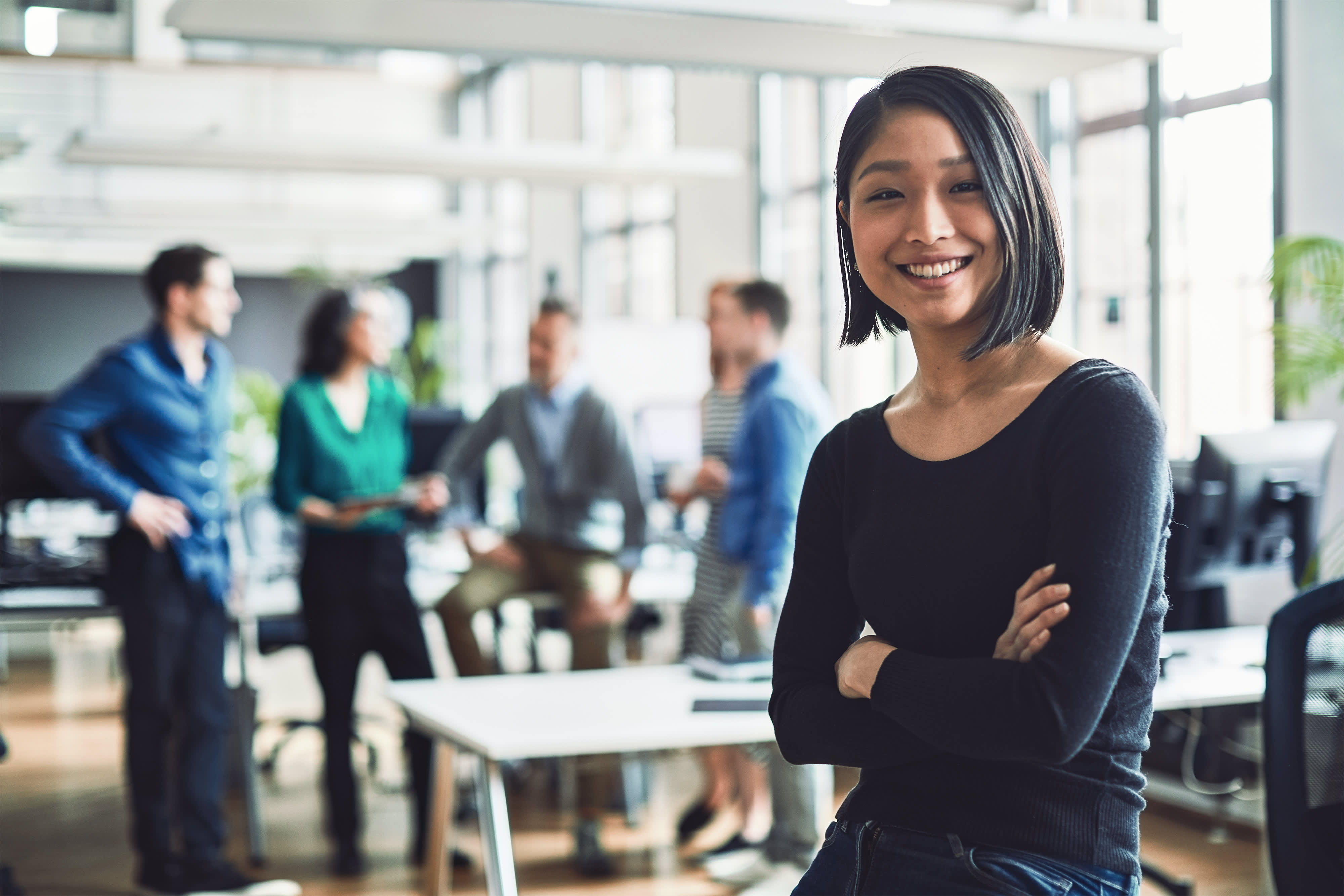 Titelbild für Infoseite “MBA - Human Resource Management”: HR Managerin steht in Großraumbüro