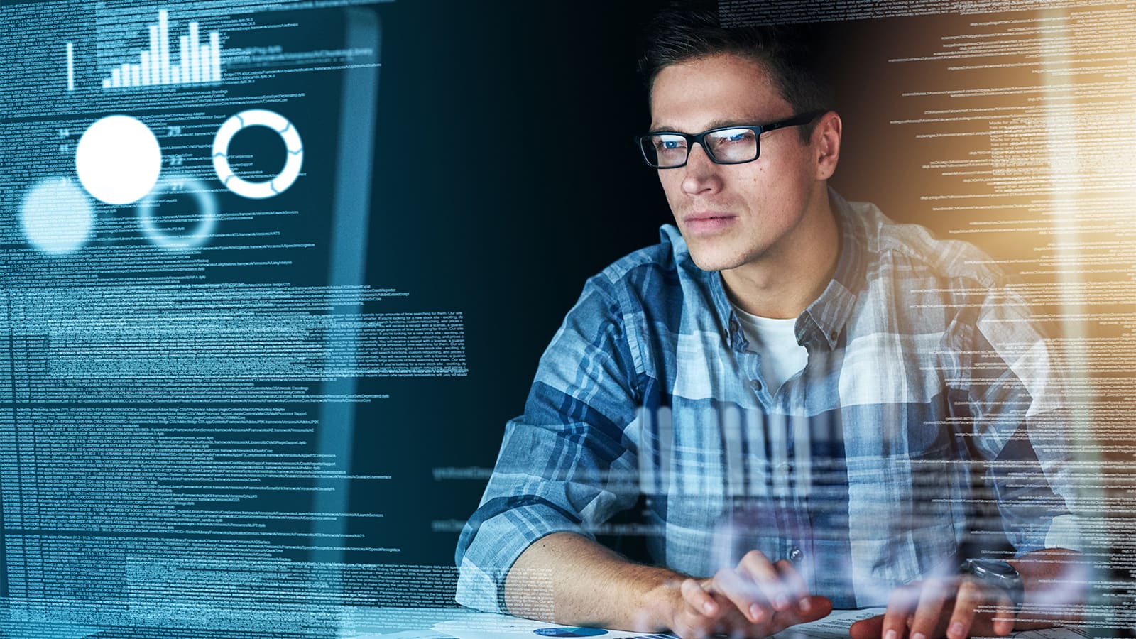 A man with glasses viewing a holographic screen