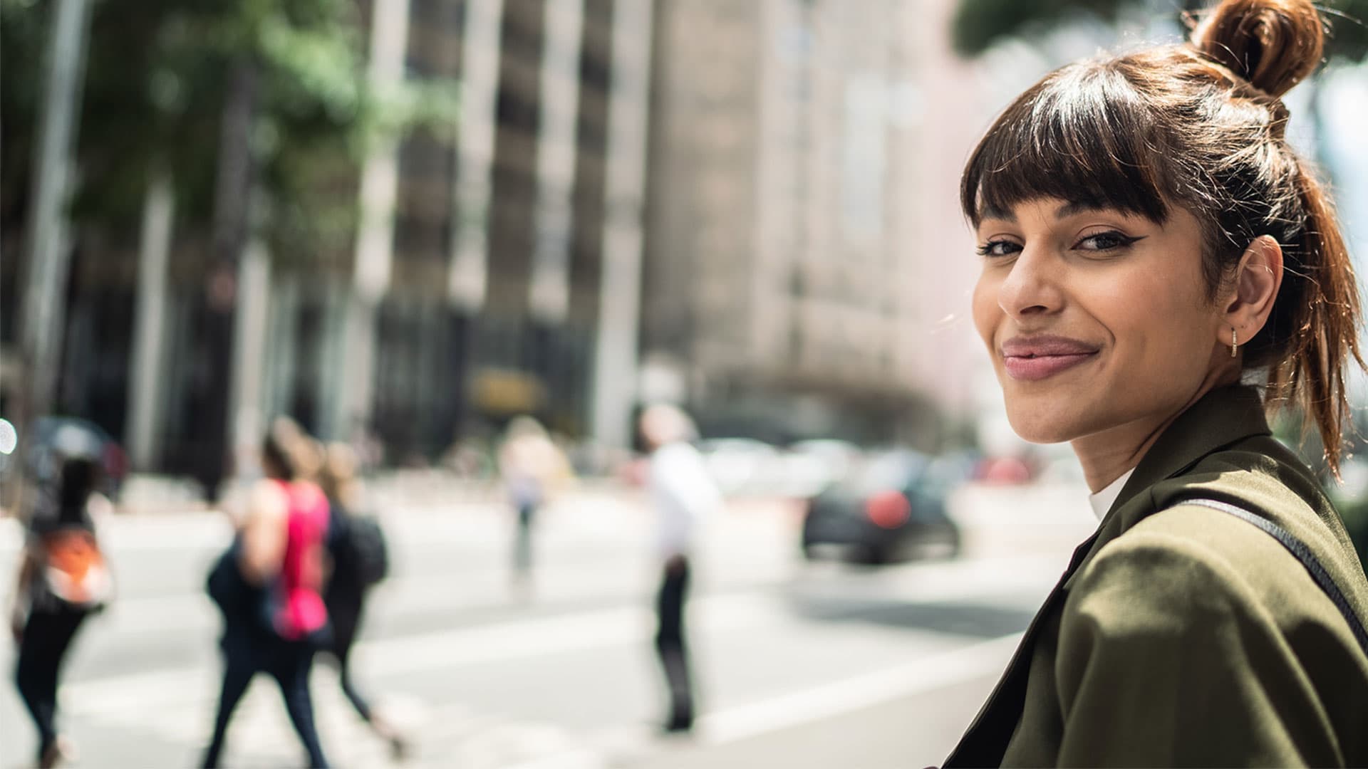 Woman, on the street, smiling to the camera
