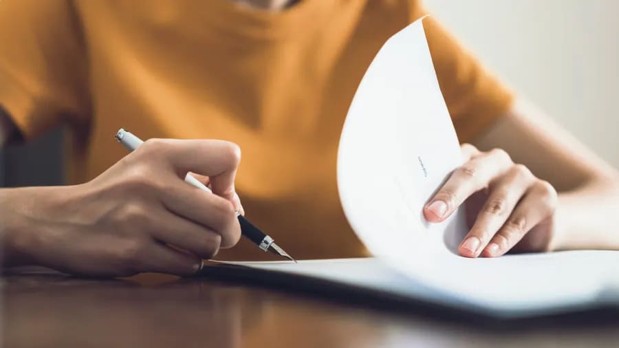 Woman signing some documents