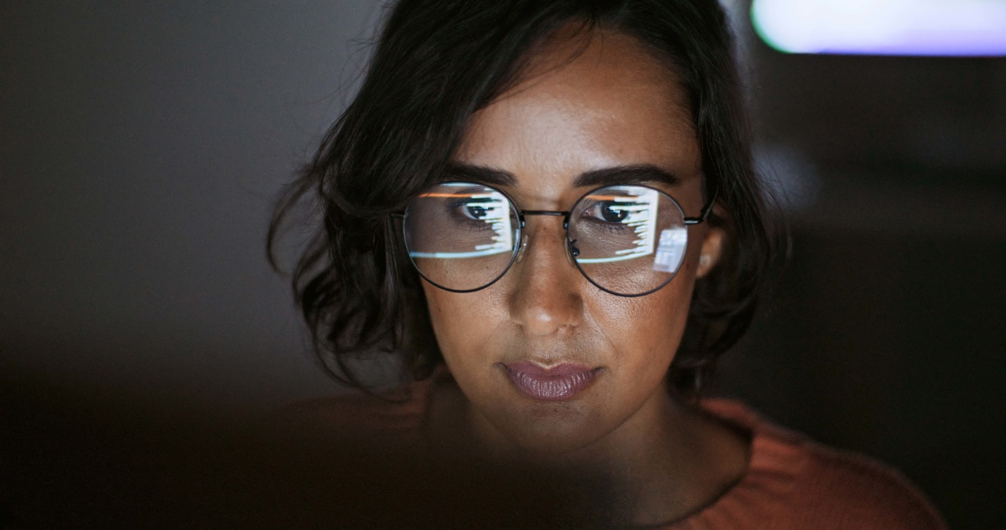 Nahaufnahme Frau mit Brille am PC