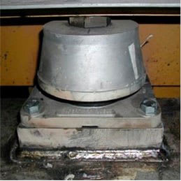 Resilient mount on a steel chock