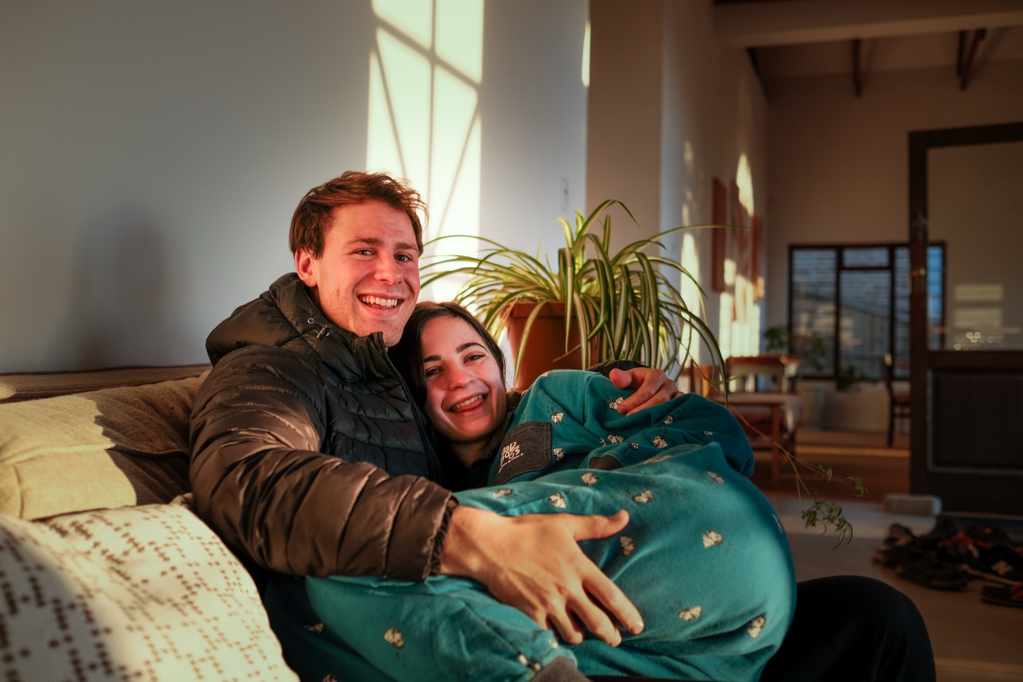 Tristan and Erin curled up together in golden evening light