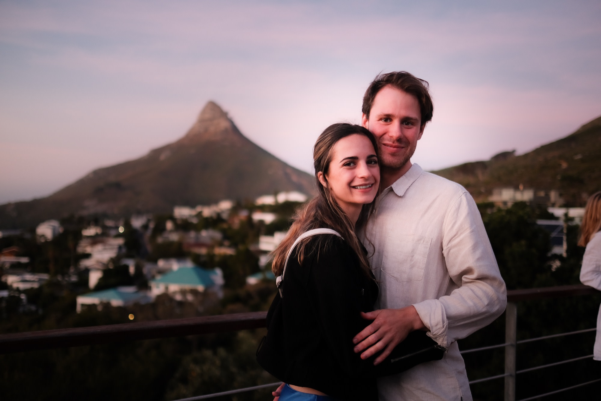 Tristan and Erin on a rooftop at sunset, Lion's Head behind them