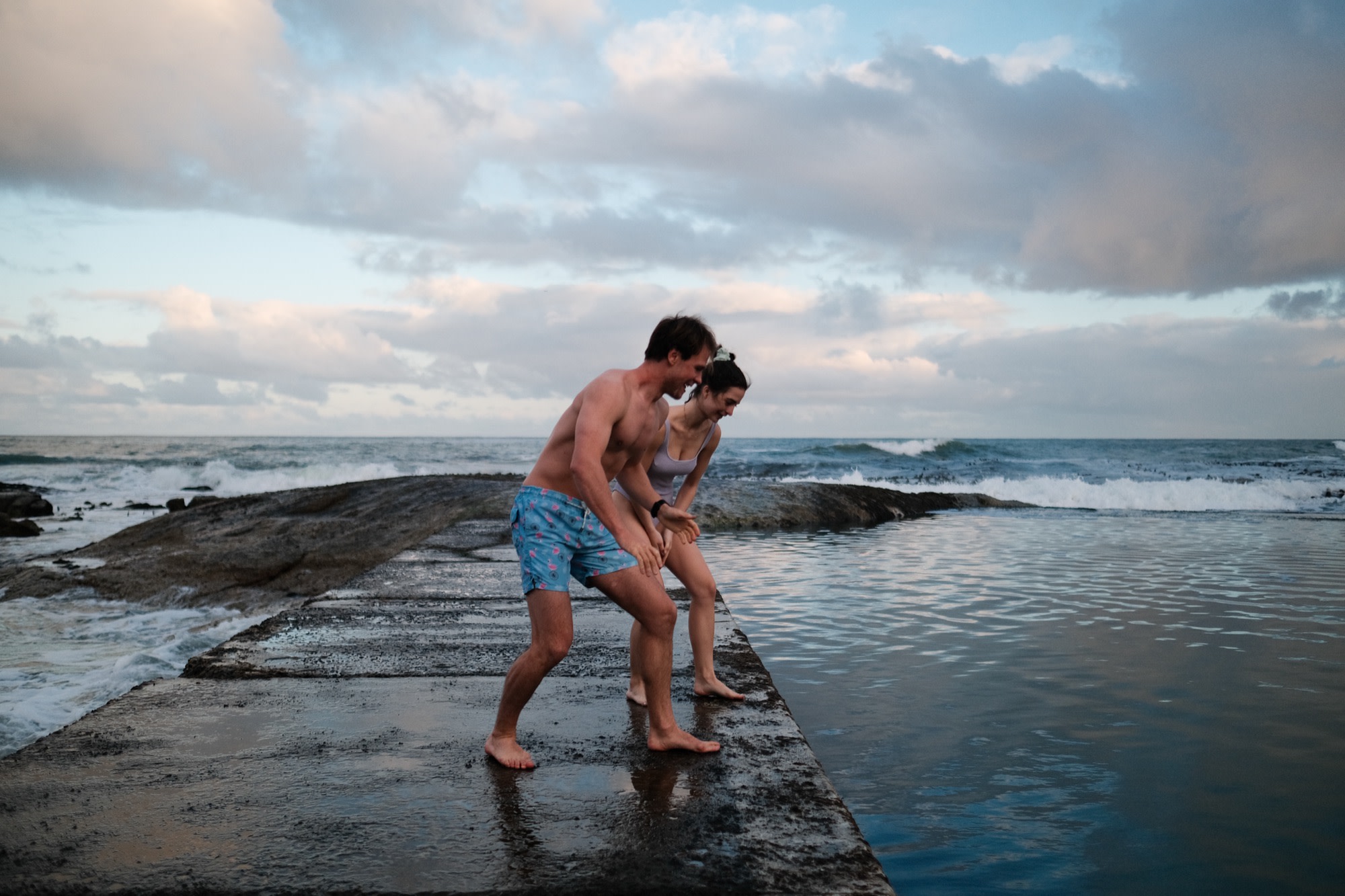 Tristan and Erin about to jump into a tidal pool at dusk