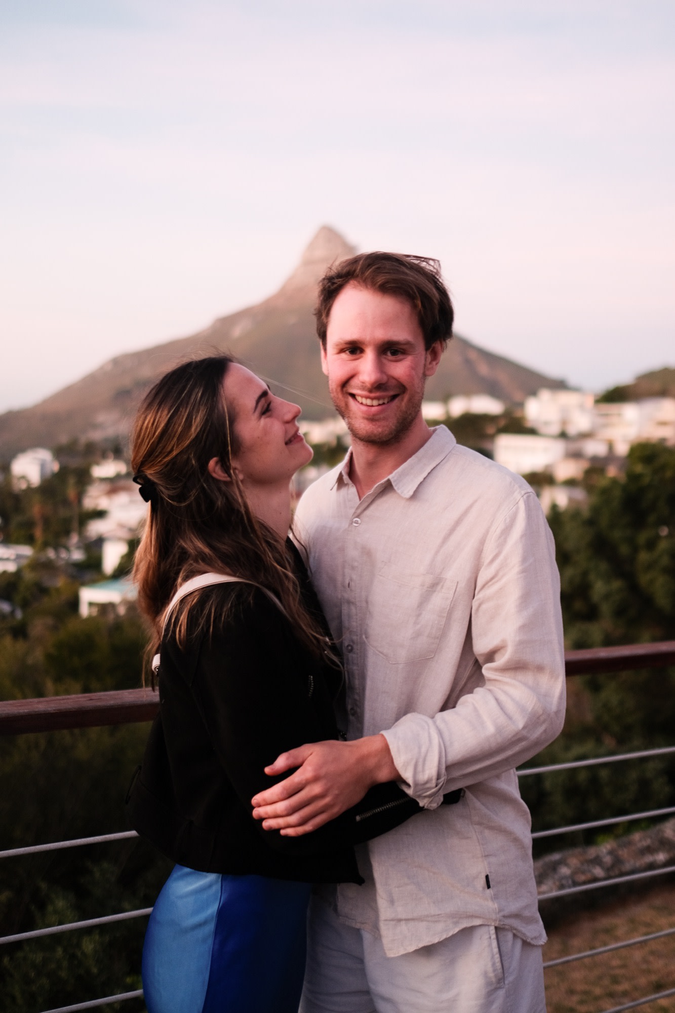 Tristan and Erin close together on a rooftop at sunset