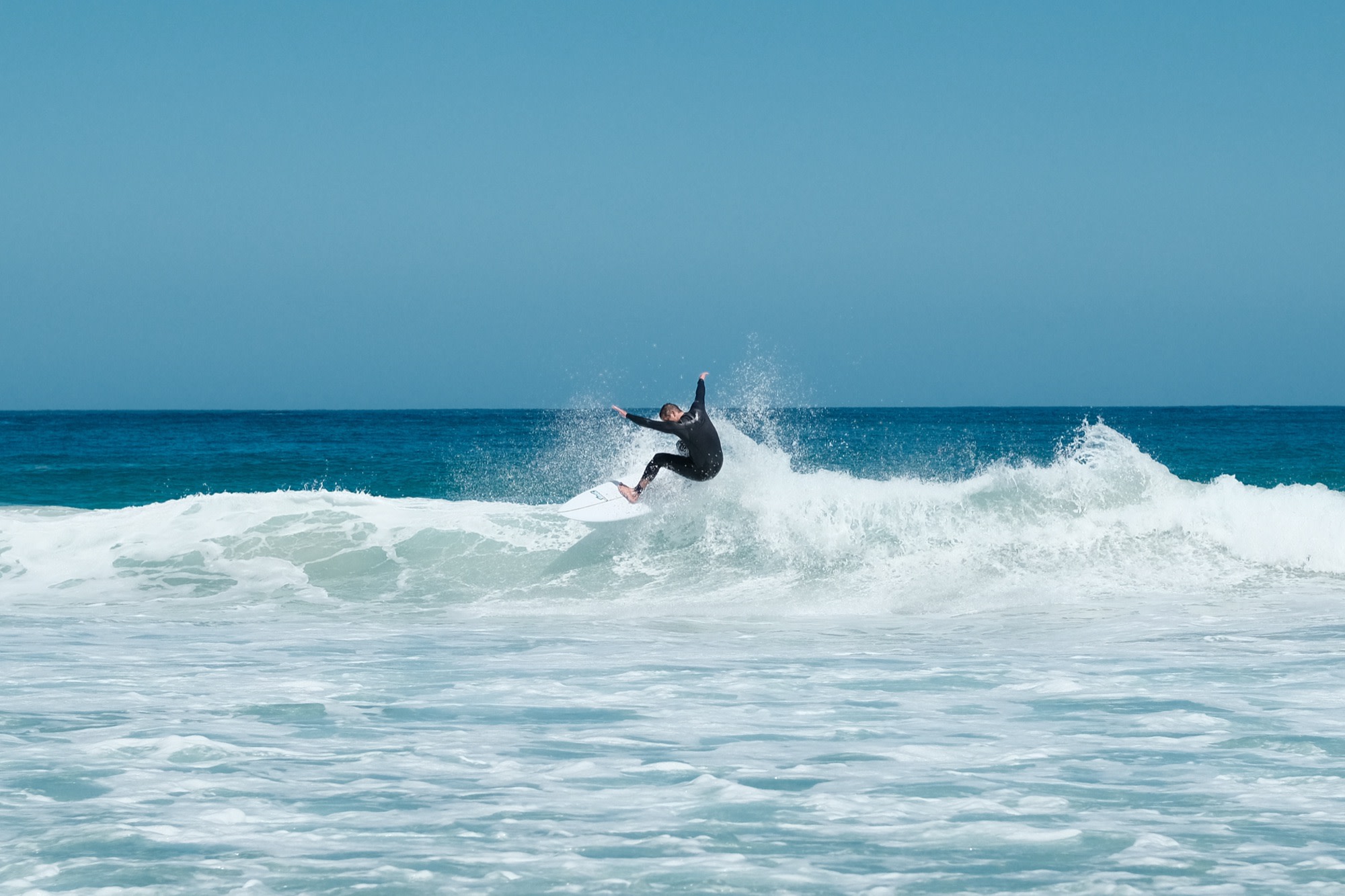 Laurence turning hard off the lip of a wave