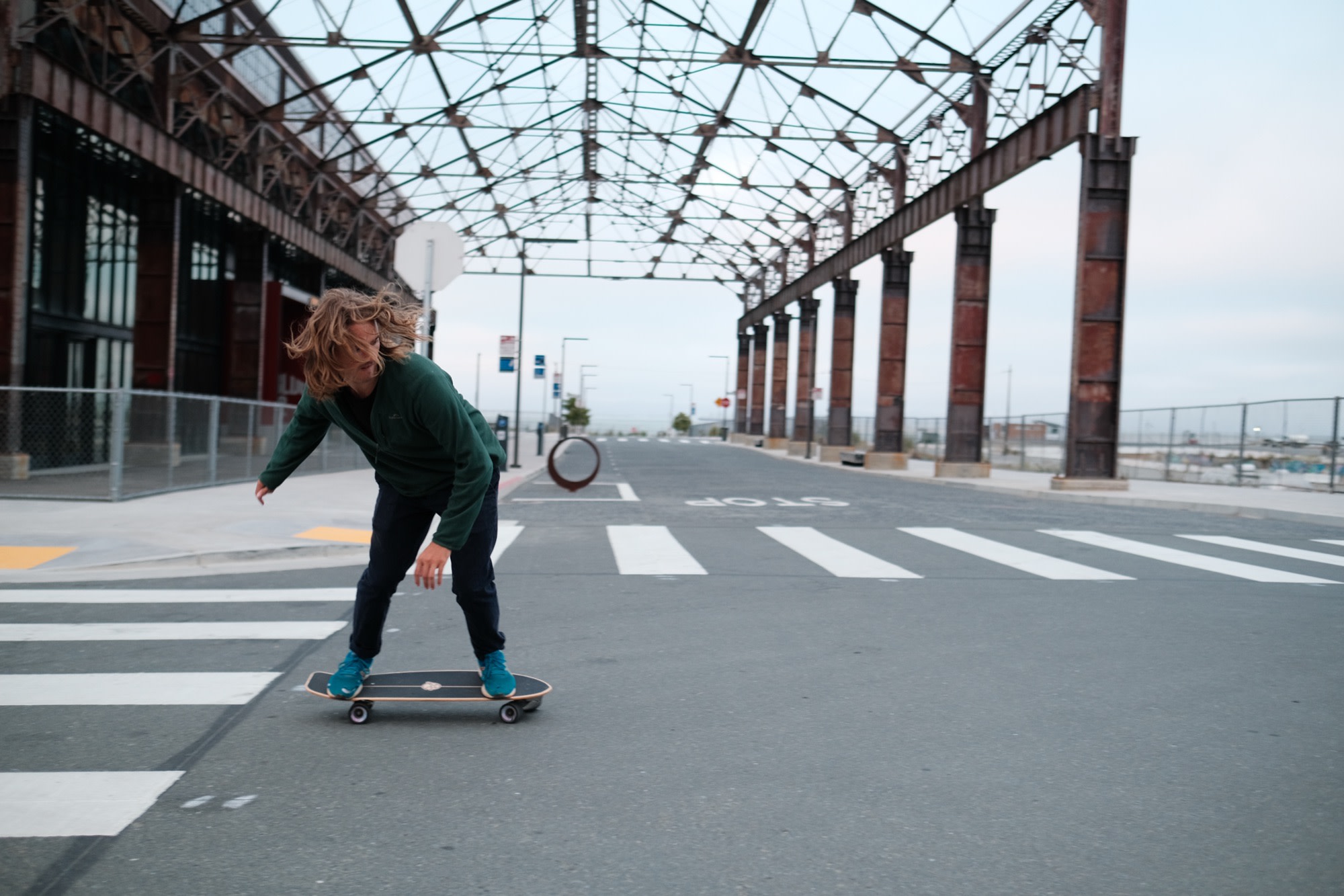 Laurence mid-carve on his skateboard