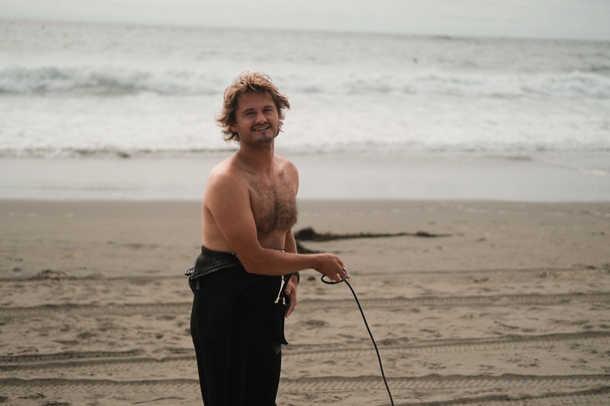 Laurence coiling his leash on the beach
