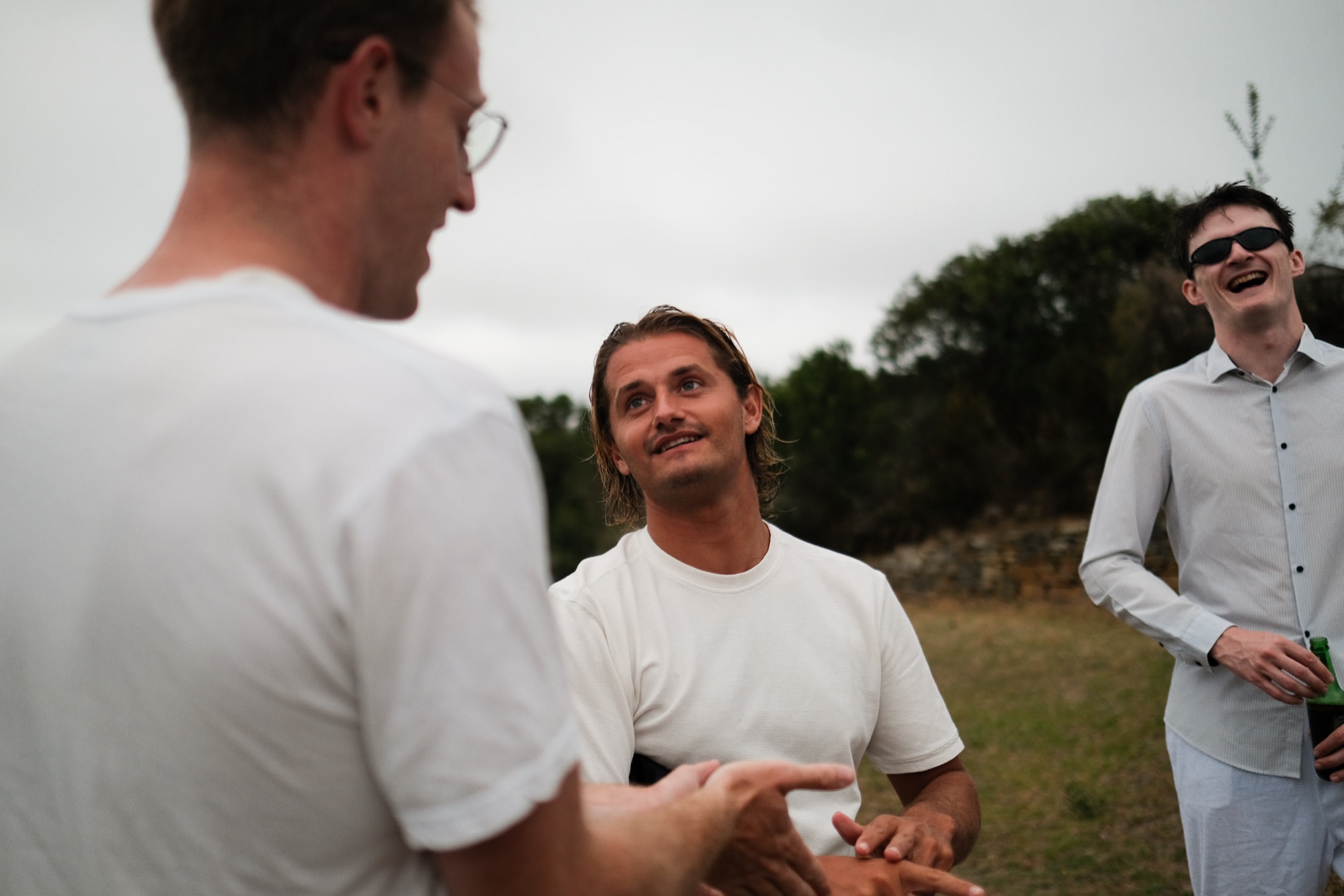 Laurence talking with friends at dusk