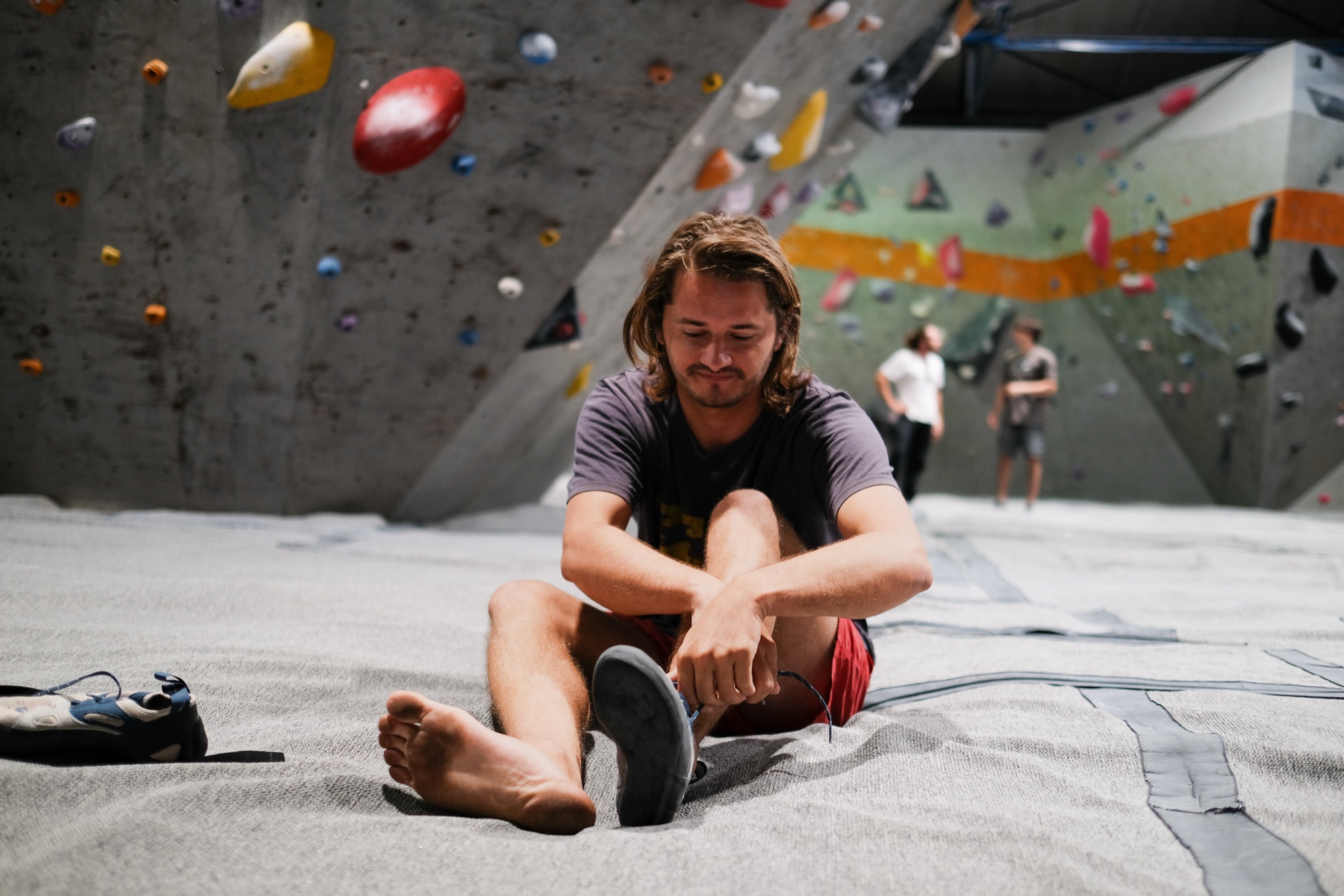 Laurence lacing up at the climbing gym