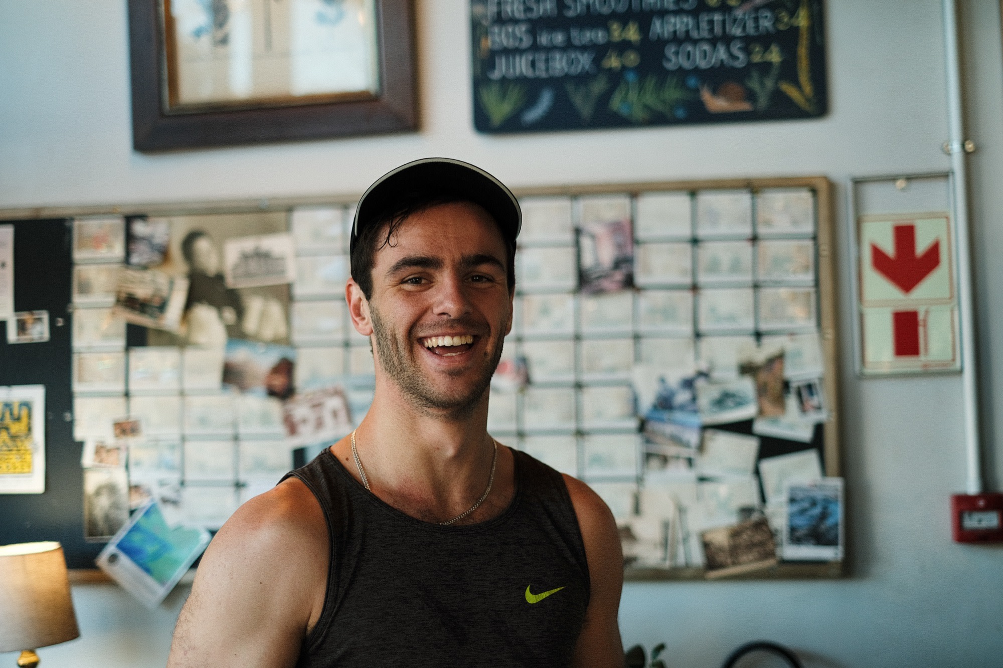 Mike laughing in a sunlit café