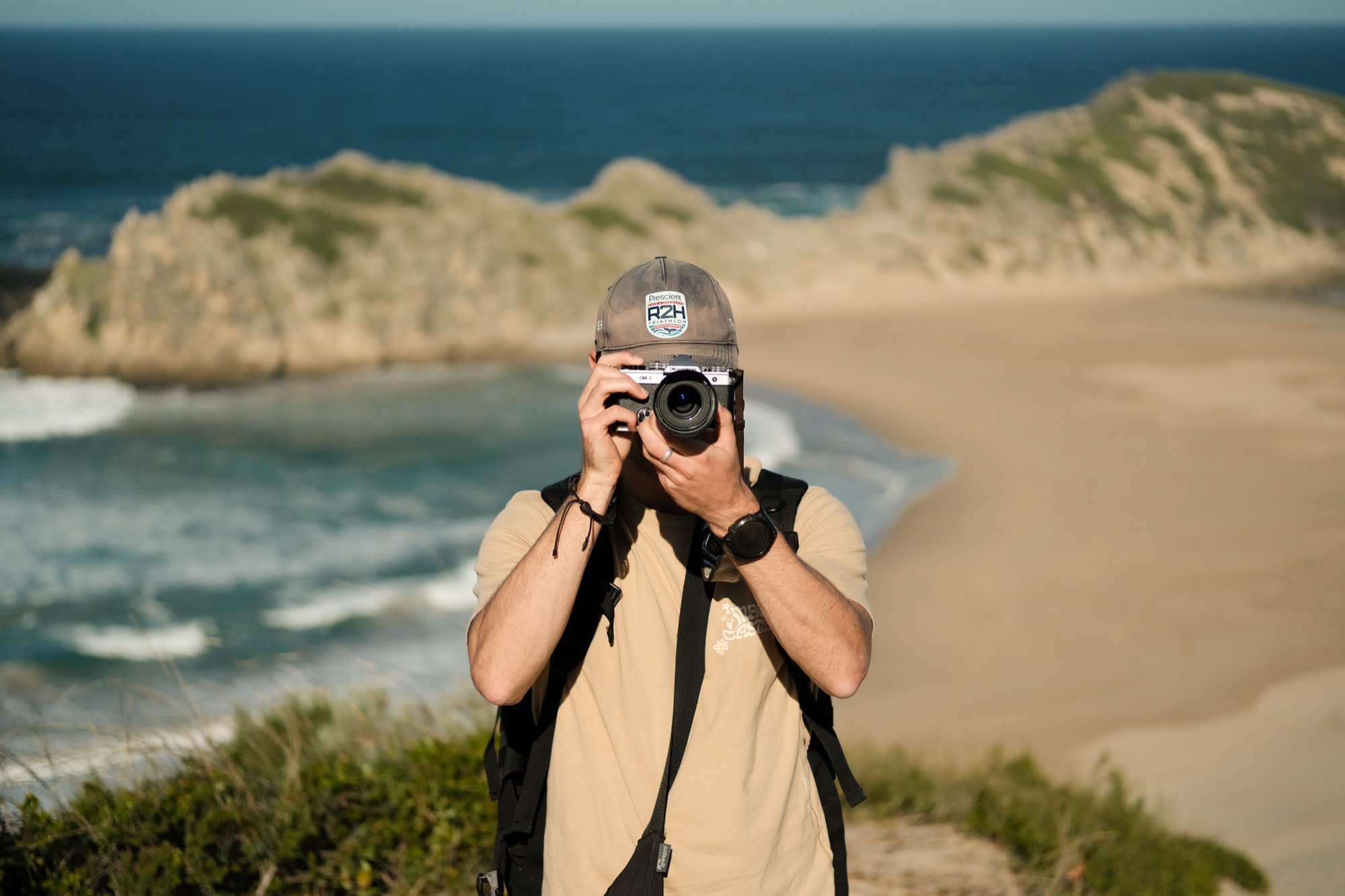 Mike raising his camera on the dunes